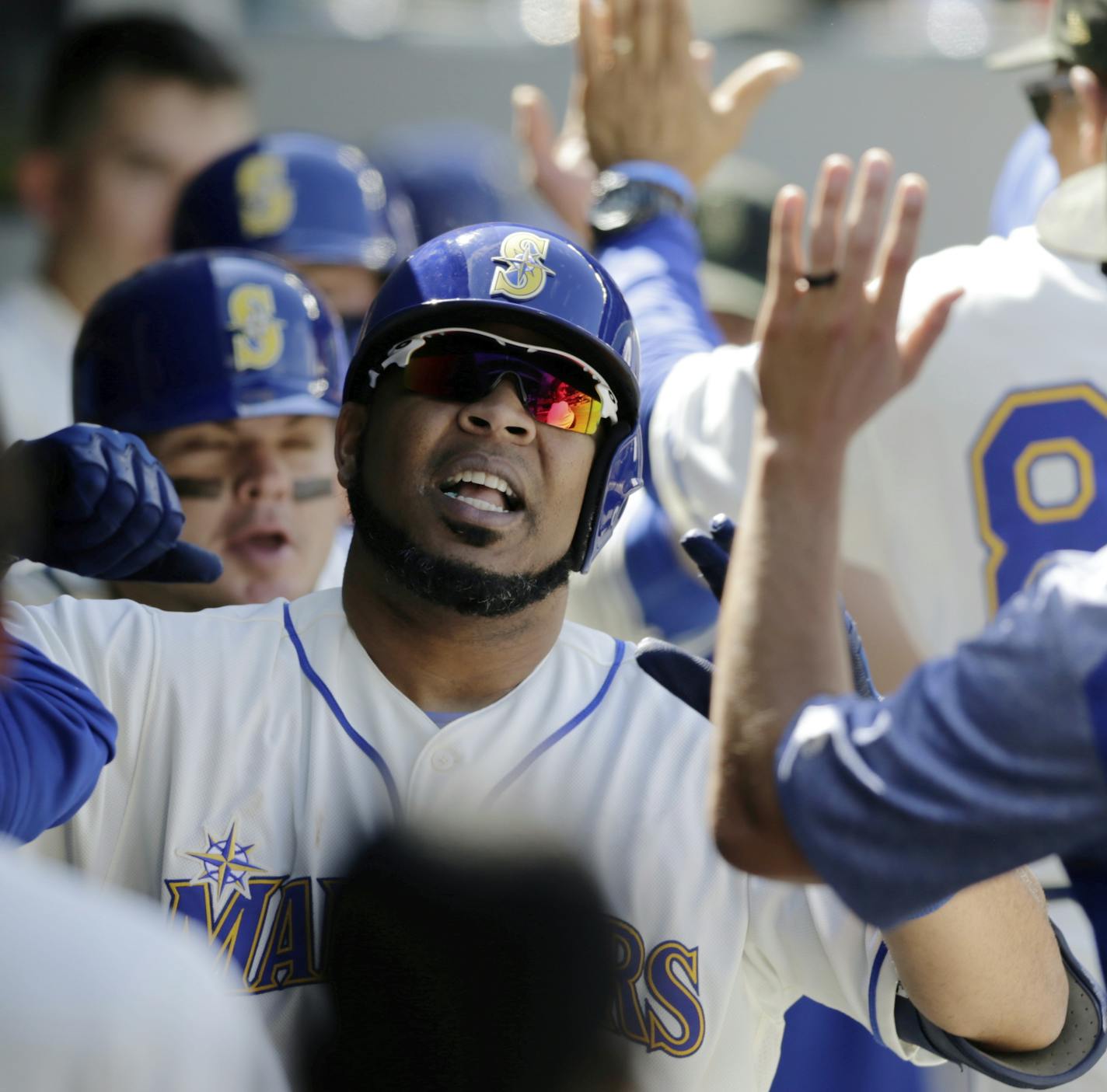 Seattle Mariners' Edwin Encarnacion in the dugout after hitting a home run against the Minnesota Twins during a baseball game, Sunday, May 19, 2019, in Seattle. (AP Photo/John Froschauer)