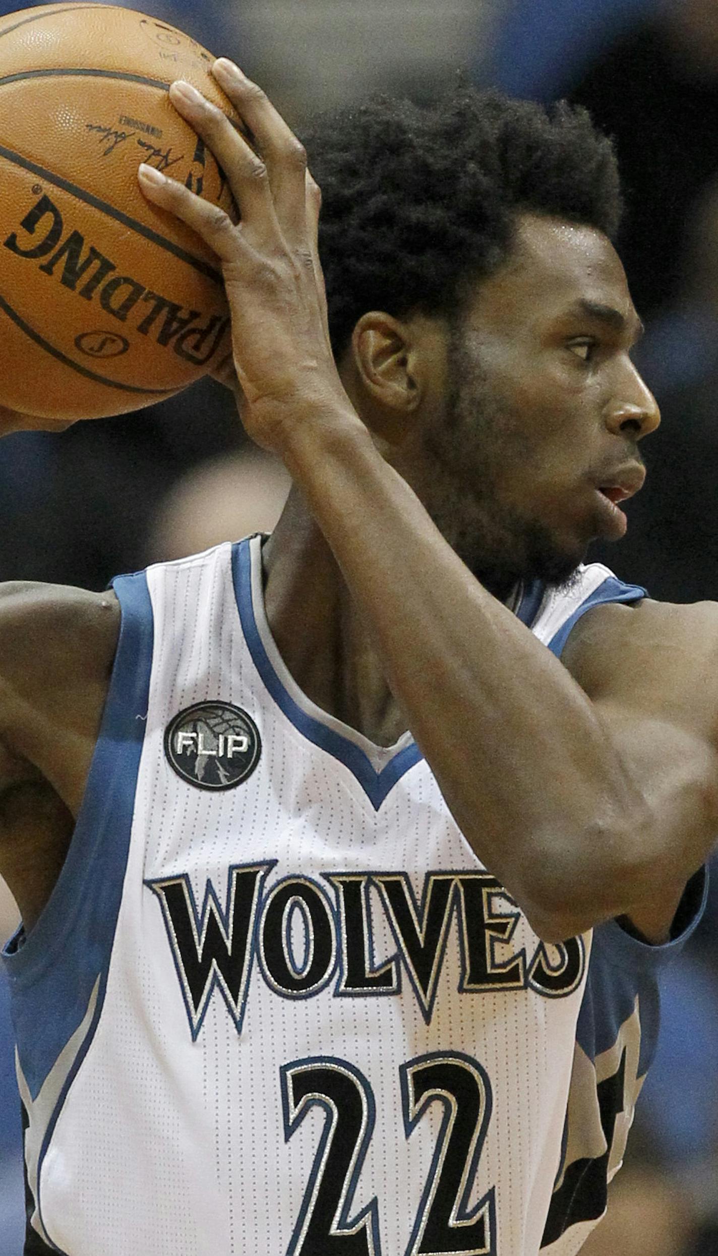 Minnesota Timberwolves guard Andrew Wiggins, left, looks to pass to a teammate under pressure from Phoenix Suns forward P.J. Tucker, right, during the second half of an NBA basketball game in Minneapolis, Sunday, Jan. 17, 2016. The Timberwolves won 117-87. (AP Photo/Ann Heisenfelt)