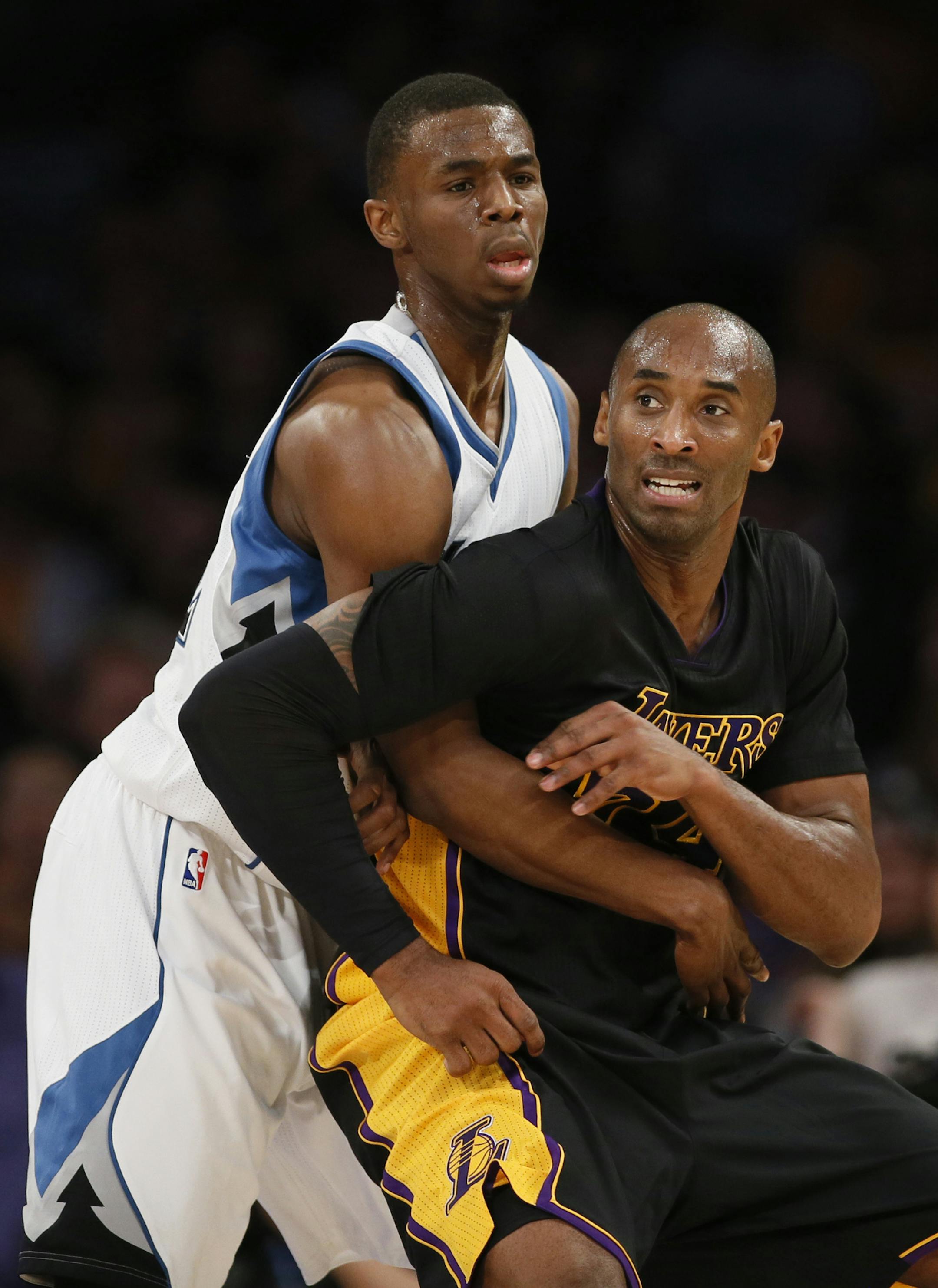 Minnesota Timberwolves' Andrew Wiggins defends against Los Angeles Lakers' Kobe Bryant during the first half of an NBA basketball game Friday, Nov. 28, 2014, in Los Angeles. (AP Photo/Danny Moloshok)