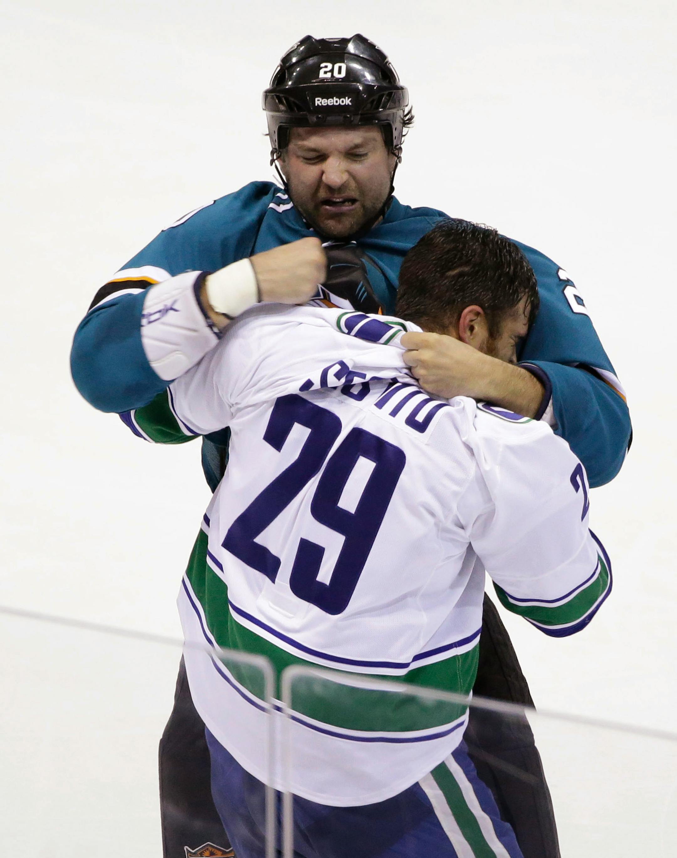 San Jose Sharks' John Scott, top, fights with Vancouver Canucks' Tom Sestito during the first period of an NHL preseason hockey game Tuesday, Sept. 23, 2014, in Stockton, Calif. (AP Photo/Marcio Jose Sanchez)