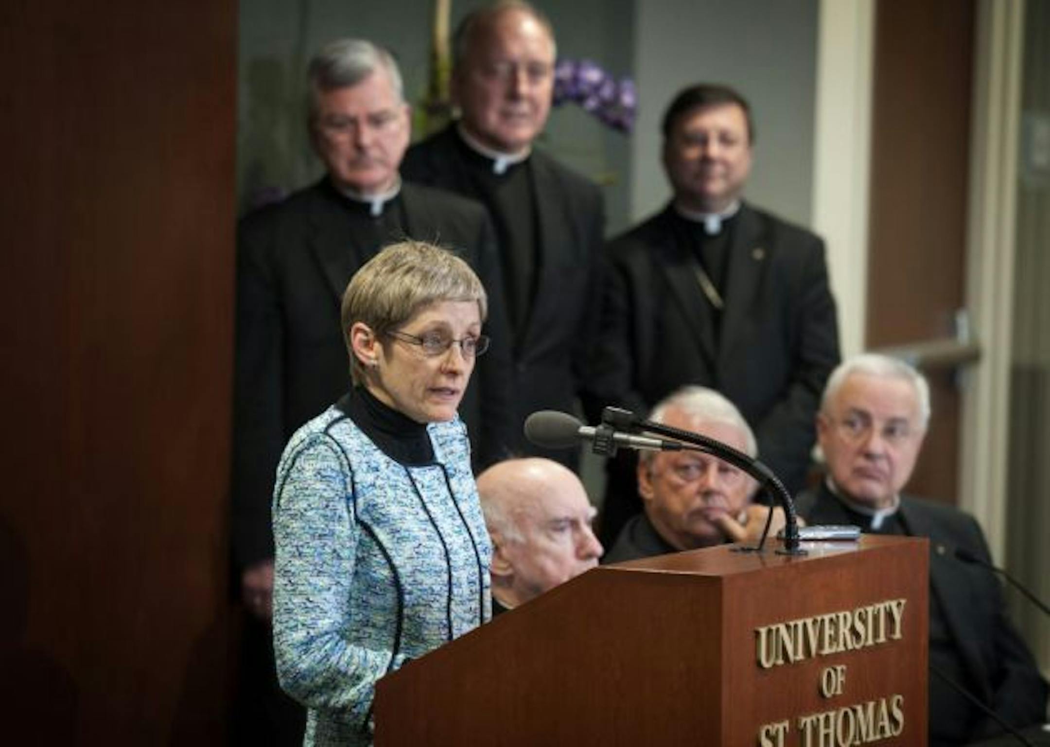 The University of St. Thomas announced its new president Julie Sullivan at a press conference today, Thursday, February 14, 2013.   She is the school's first female and first lay person to serve as president.  The Board of Trustees this morning elected the successor to Father Dennis Dease, who will retire June 30 after 22 years as 14th president of Minnesota's largest private college or university.     ]   GLEN STUBBE * gstubbe@startribune.com  EDS:  behind her are l to r top, Archbishop John Nienstedt, Fr. Kevin McDonough and Bishop Lee Piche.  Bottom: Archbishop Terry Flynn, search committee chair John Morrison and Fr. Dennis Dease.
