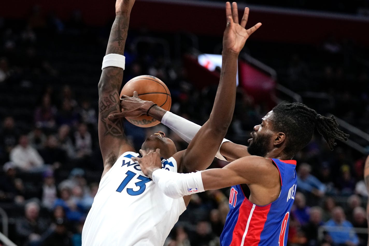 Detroit Pistons' Nerlens Noel (9) fouls Minnesota Timberwolves forward Nathan Knight (13) in the second half of an NBA basketball game in Detroit, Wednesday, Jan. 11, 2023. (AP Photo/Paul Sancya)