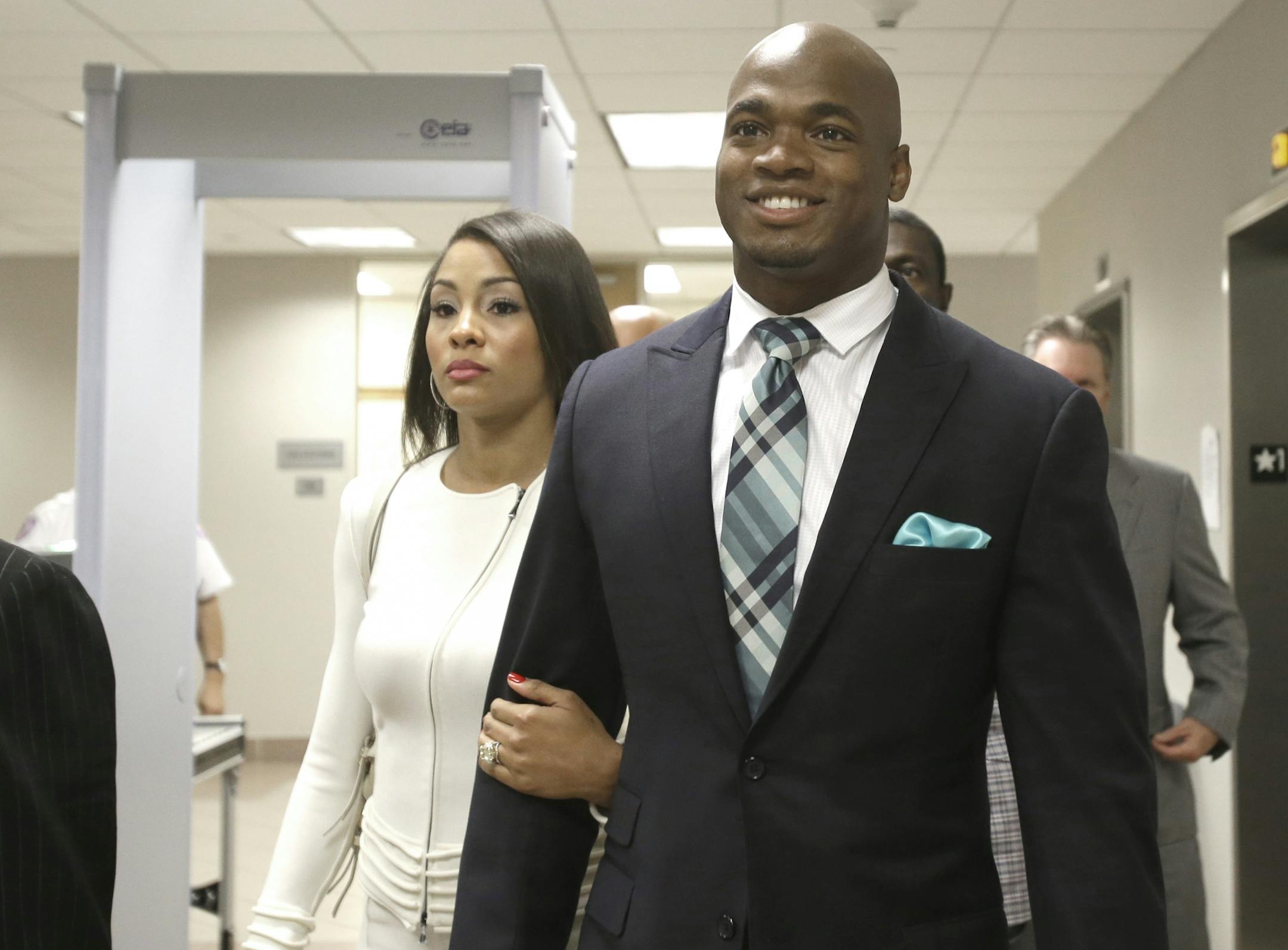 Minnesota Vikings running back Adrian Peterson leaves the courthouse with his wife Ashley Brown Peterson Tuesday, Nov. 4, 2014, in Conroe, Texas. Adrian Peterson avoided jail time on in a plea agreement reached with prosecutors to resolve his child abuse case.