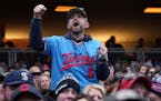 Twins fans cheer during their home opener against the Cleveland Guardians Thursday, April 4, 2024 at Target Field in Minneapolis.  ] ANTHONY SOUFFLE �