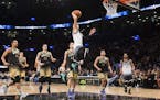 United States' Zach LaVine dunks in front of World players during the second half of the NBA Rising Stars Challenge basketball game in Toronto on Frid