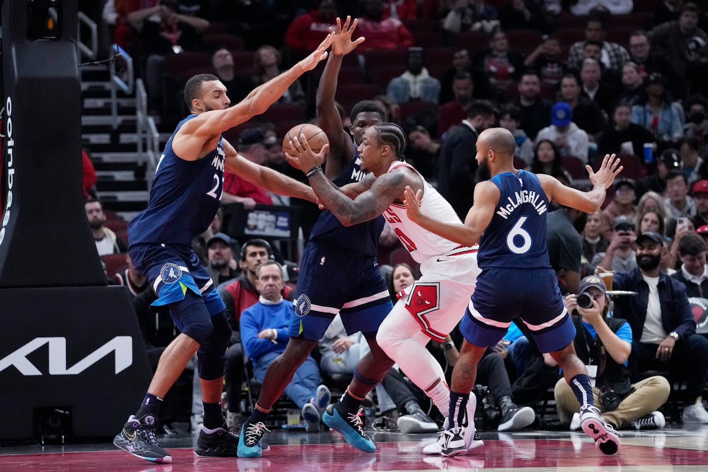 CORRECTS TO TIMBERWOLVES GUARD ANTHONY EDWARDS NOT FORWARD KYLE ANDERSON - Minnesota Timberwolves center Rudy Gobert, left, guard Anthony Edwards, second from left, and guard Jordan McLaughlin (6) guard against Chicago Bulls forward DeMar DeRozan during the first half of an NBA preseason basketball game in Chicago, Thursday, Oct. 19, 2023. (AP Photo/Nam Y. Huh)