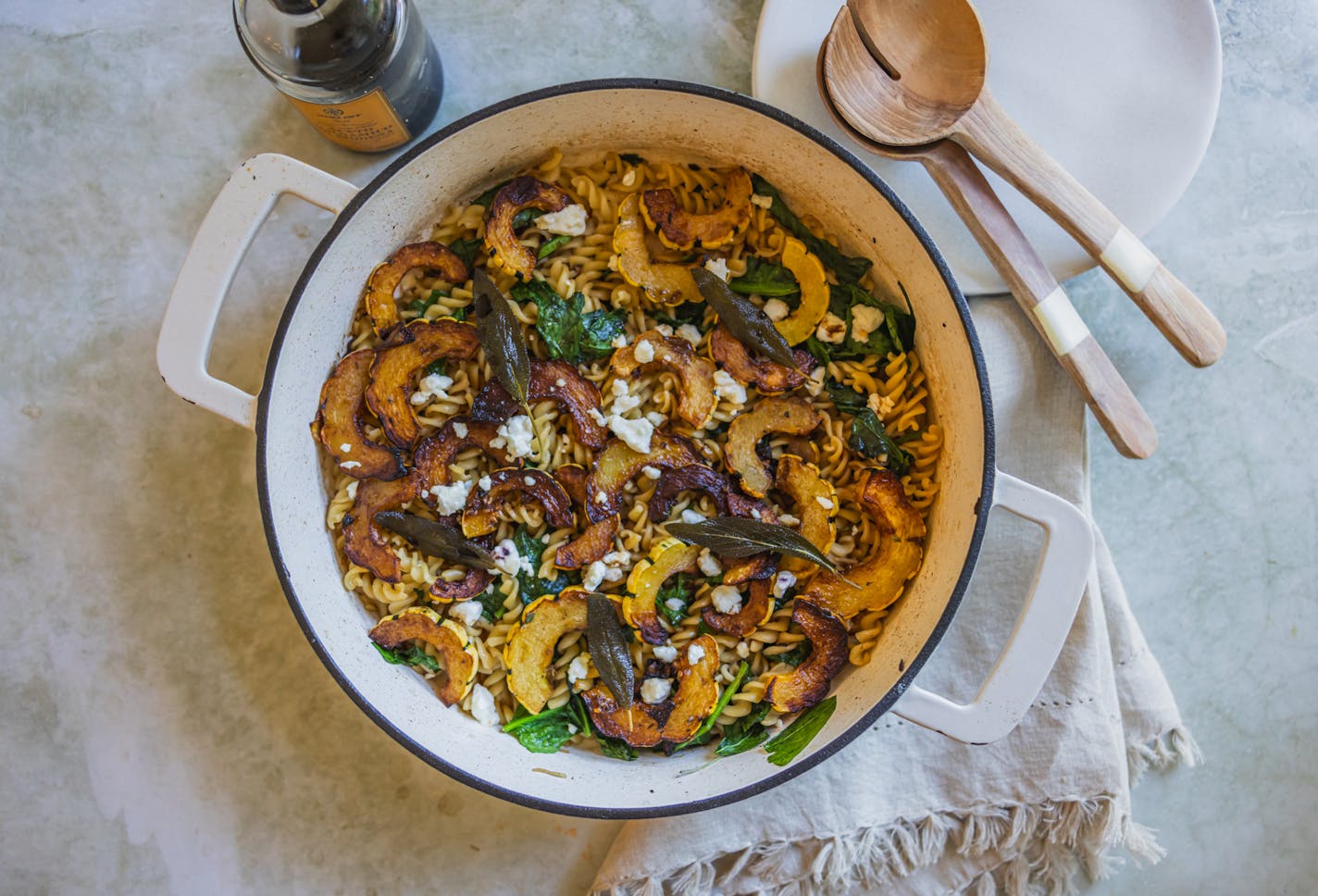 A one-pan pasta dish with delicata squash, spinach and browned butter that's topped with a splash of balsamic and chevre.