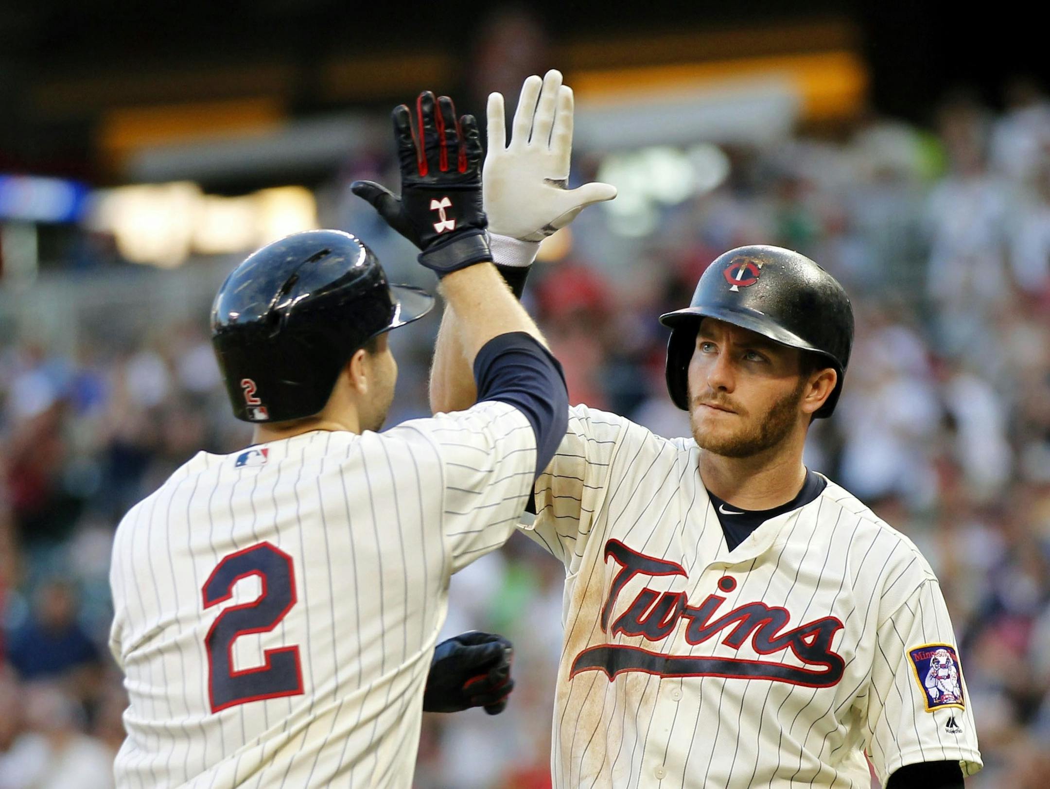 Minnesota Twins Brian Dozier (2) is congratulated by Twins' Robbie Grossman (36) after Dozier hit a home run against the Kansas City Royals in the sixth inning on Saturday, Aug., 13, 2016, in Minneapolis. The Twins defeated the Royals 5-3. (AP Photo/Andy Clayton-King)