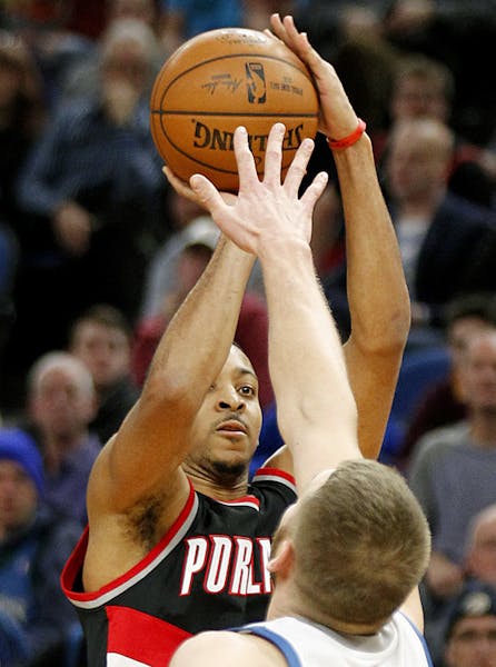 Portland Trail Blazers guard C.J. McCollum shoots in front of Minnesota Timberwolves center Cole Aldrich during the fourth quarter of an NBA basketbal