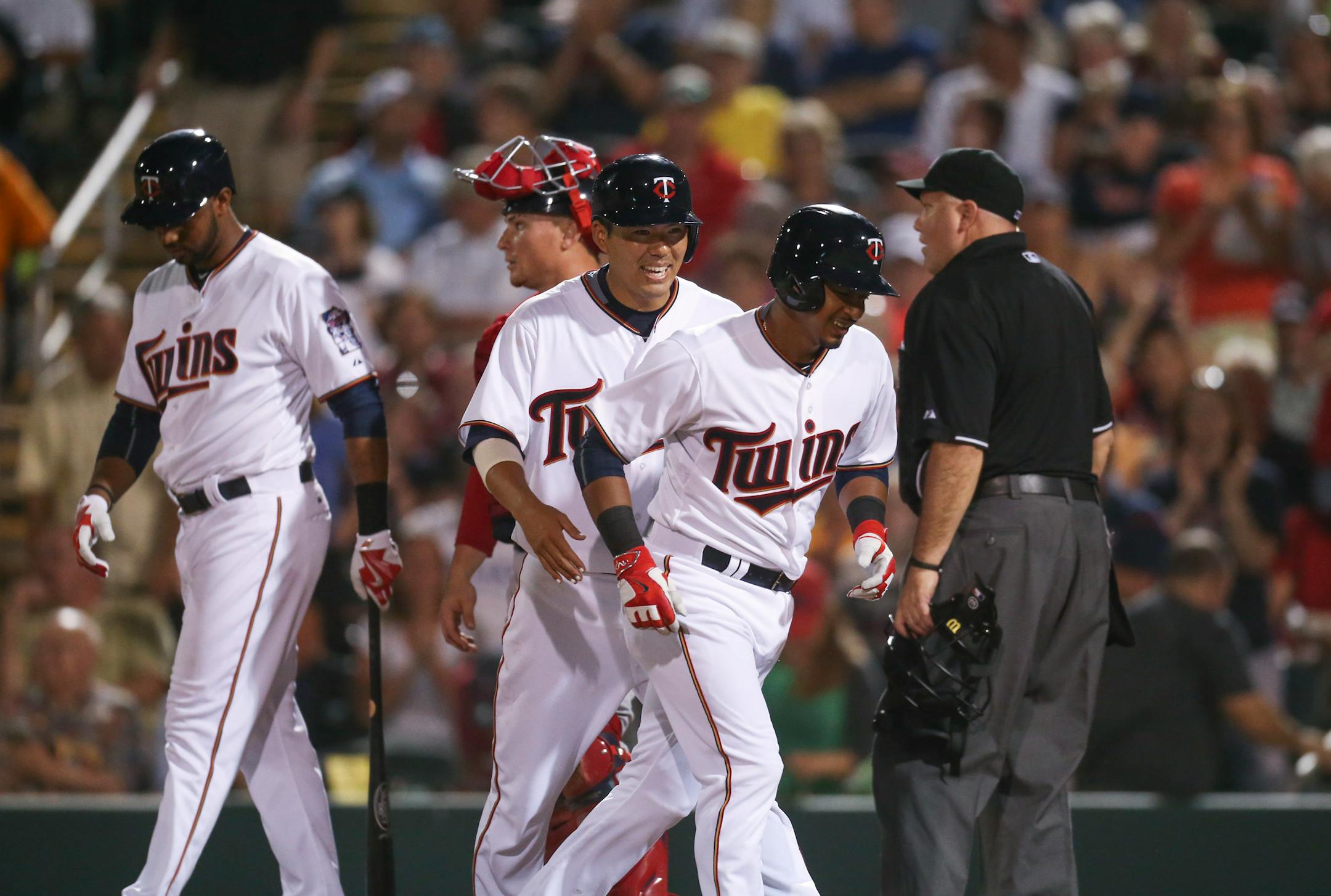 Minnesota Twins Eduardo Escobar, foreground, and Kurt Suzuki headed for the dugout after Escobar hit a two run homer in the third inning that scored Suzuki and put the twin ahead of Boston 6-4 Thursday evening at Hammond Stadium.