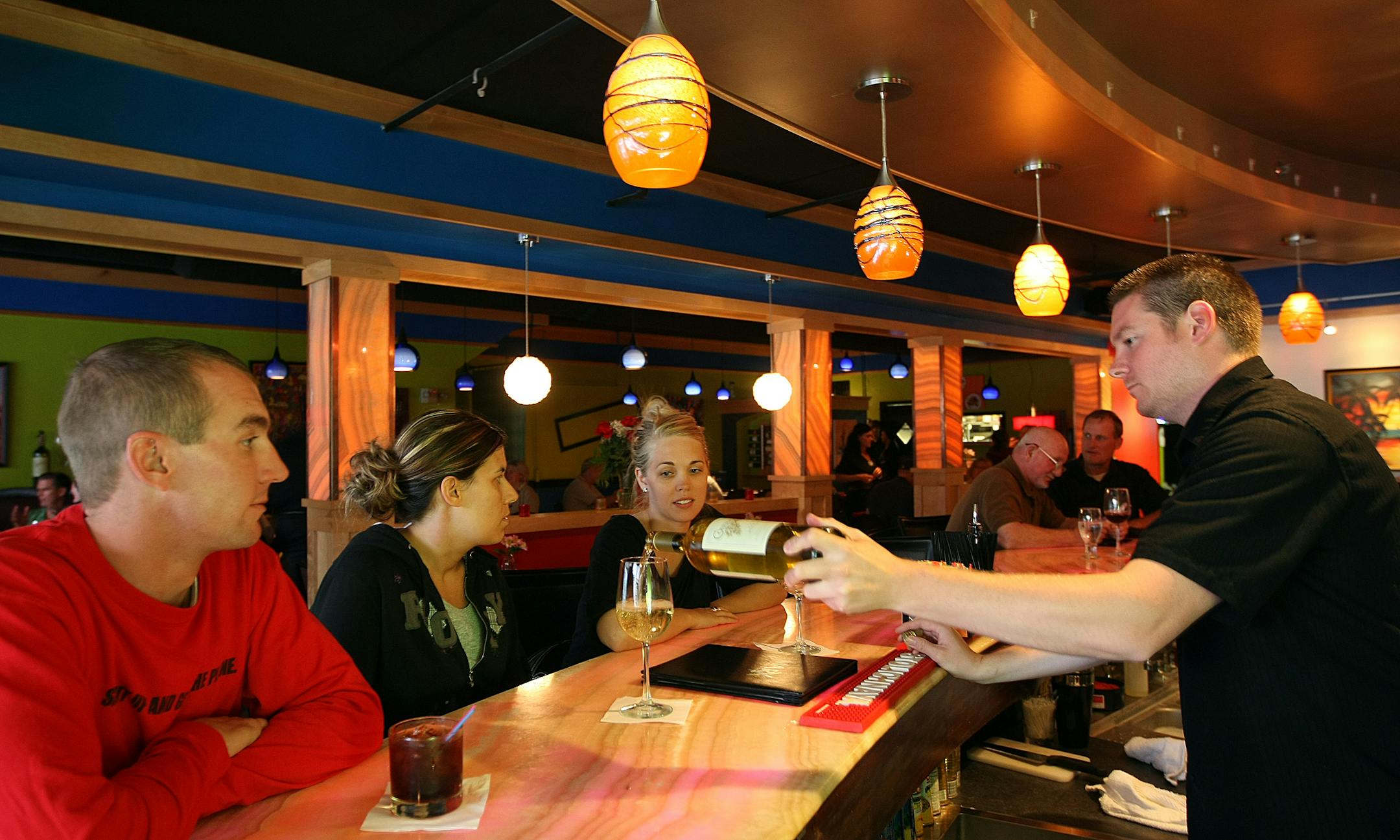 The bar side of Marx in Stillwater offers space for a more casual experience than in its dining room. From right, Amber Schultz of Houlton, Wis., Sarah Niederer of Hudson, Wis., and Eric Simon of Fort Lauderdale, Fla., were served drinks by Eric McCann.