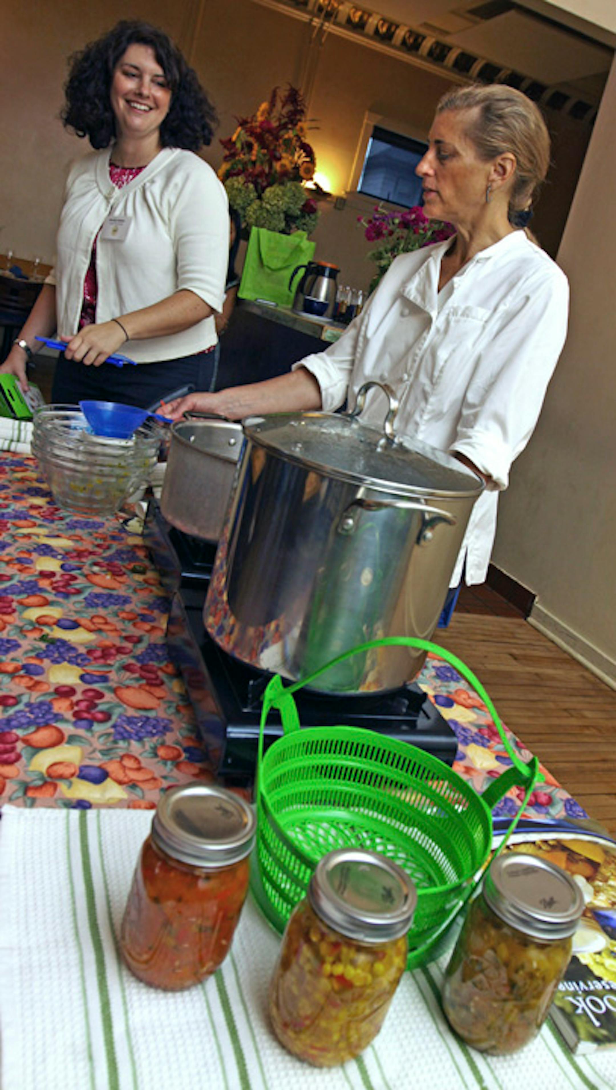 Shirley Hutner and Lucia Watson demonstrate home canning at Lucia's Restaurant.