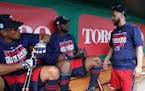 Newly acquired Minnesota Twins utility player Marwin Gonzalez (9) talked with shortstop Jorge Polanco (11) and third baseman Miguel Sano (22) in the d