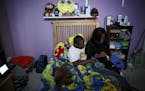 Marlo Dean gives her son Dante' Herrera his morning medicines while getting ready for school at their home in March 2019. Dante' loves cartoons, inclu