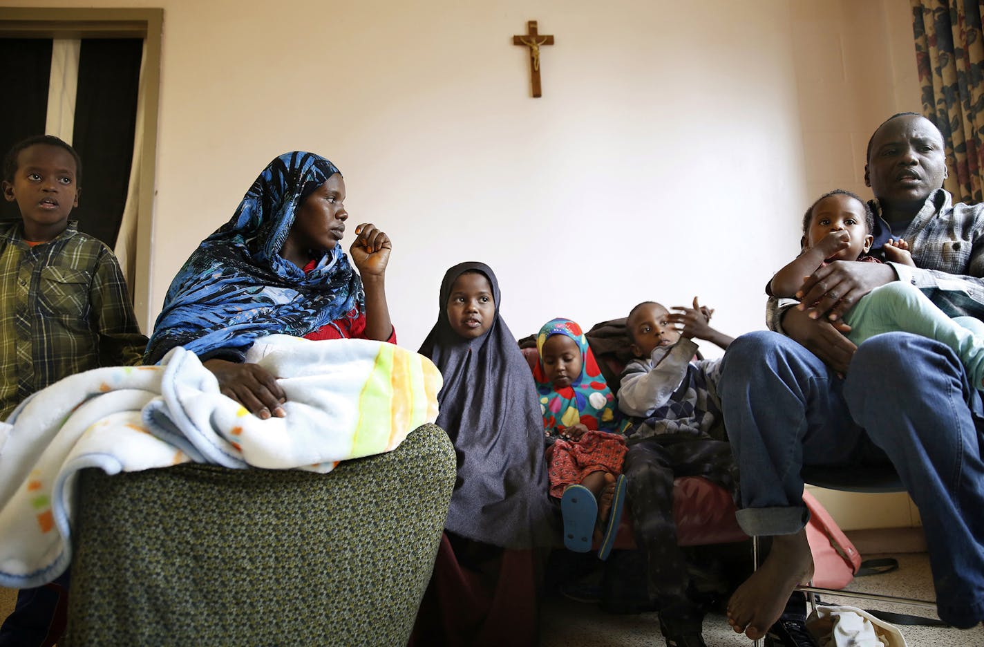 Recent Somali immigrants Nur Ali, right, and his wife Mahado Mohamed, left, sit with their six children Shukri Shukri, from left, 9, one-week-old Ifrah Shukri, in her mother's arms, Ugbad Shukri, 7, Hafifa Shukri, 4, Antar Shukri, 10, and one-year-old Ikra Shukri in their apartment at Mary's Place transitional apartments in downtown Minneapolis. The family arrived in the United States four months ago, first landing in Connecticut before coming to Minnesota. ] LEILA NAVIDI leila.navidi@startribun