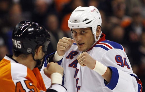 Nov. 4, 2010: Philadelphia's Jody Shelley, left, and New York Rangers' Derek Boogaard fight during an NHL gam.