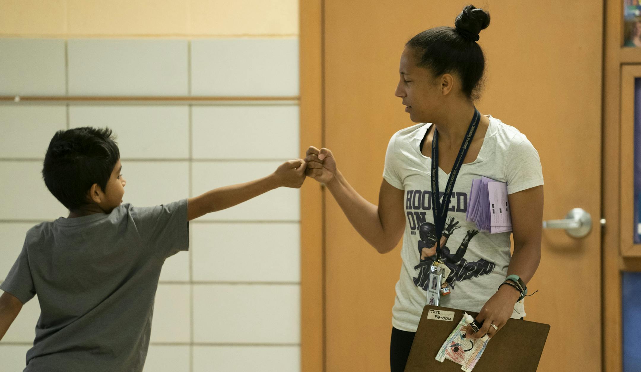 ESL teacher Olutoye Mortland gave second grader Miguel Leandro Stevens a fist pump at the end of class at Centennial Elementary School in Richfield, Minn., on Tuesday, May 7, 2019. Mortland's position is funded through compensatory funding that's meant to help with student achievement. ] RENEE JONES SCHNEIDER &#xa5; renee.jones@startribune.com