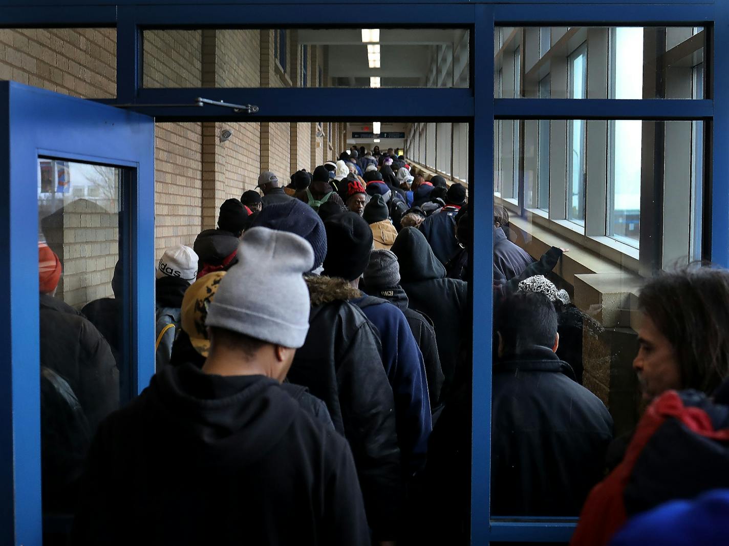 For some social distancing works, for the poor and homeless, getting food to eat doesn't always allow that as evidenced by the line for lunch at Sharing & Caring Hands Tuesday, March 24, 2020 in Minneapolis, MN. People in the line complained of a lack of safe places to go during the day with places like public libraries now closed and also said the lines for services for the homeless appears to be quickly growing.