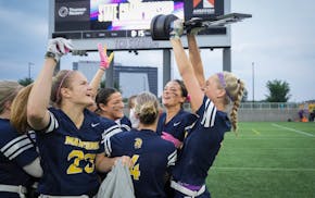 Mahtomedi's players celebrate their girls flag football state championship.