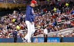 Minnesota Twins manager Paul Molitor walks back to the dugout after one of three pitching changes during the seventh inning of a baseball game against
