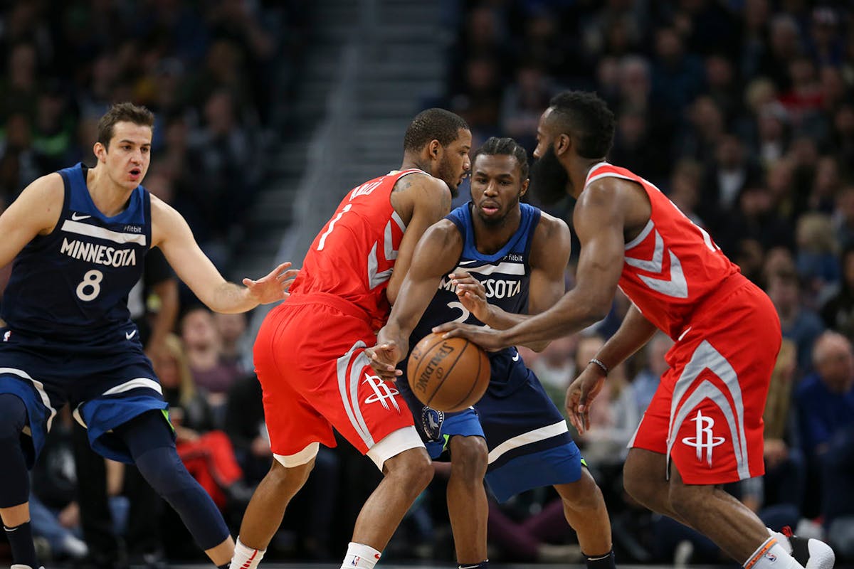 Timberwolves forward Andrew Wiggins (22) screened by Houston forward Trevor Ariza (1) as Rockets guard James Harden moved the ball upcourt in the firs