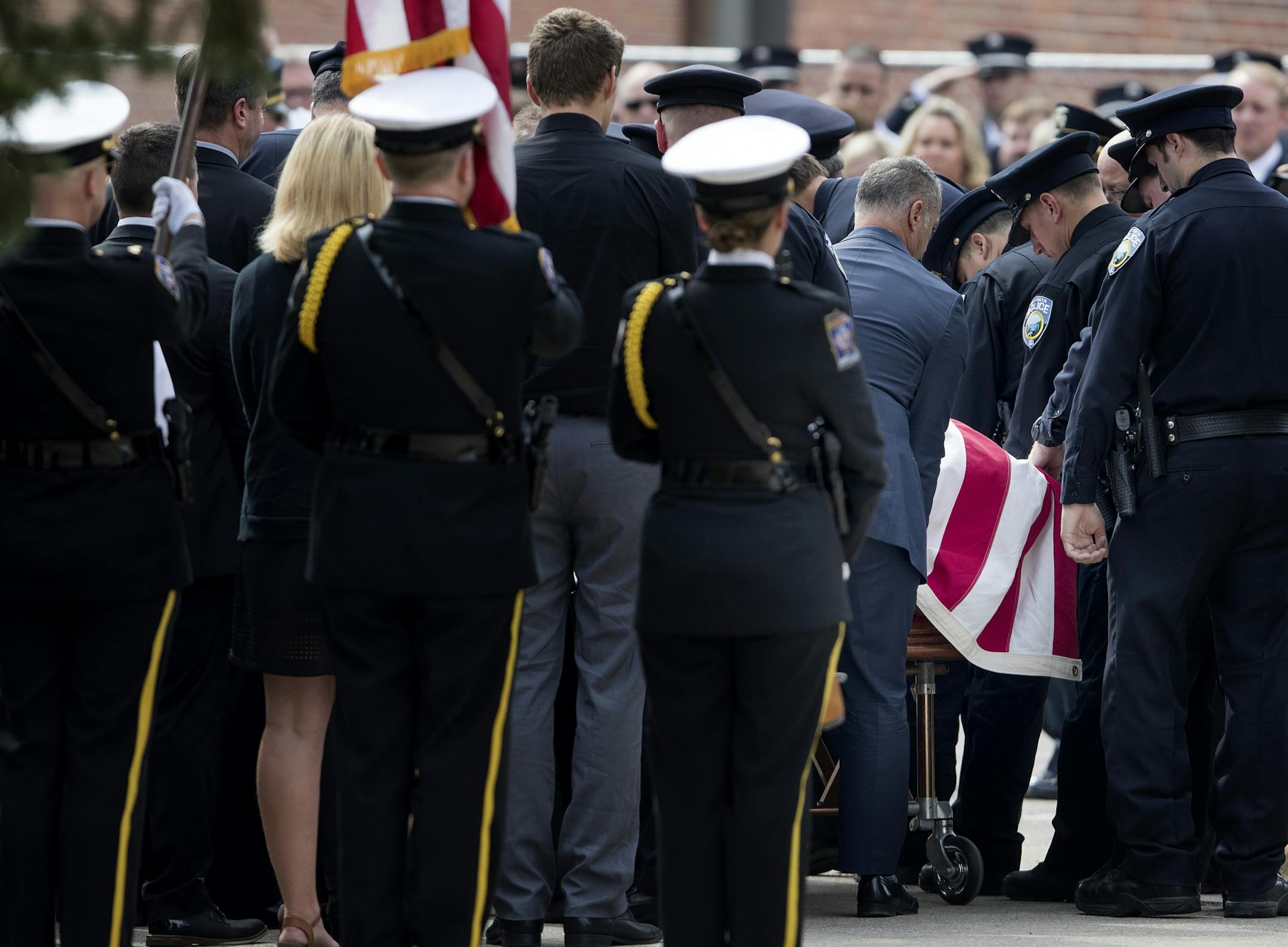 The casket of officer William Mathews was placed in a hearse at the Wayzata Free Church. service