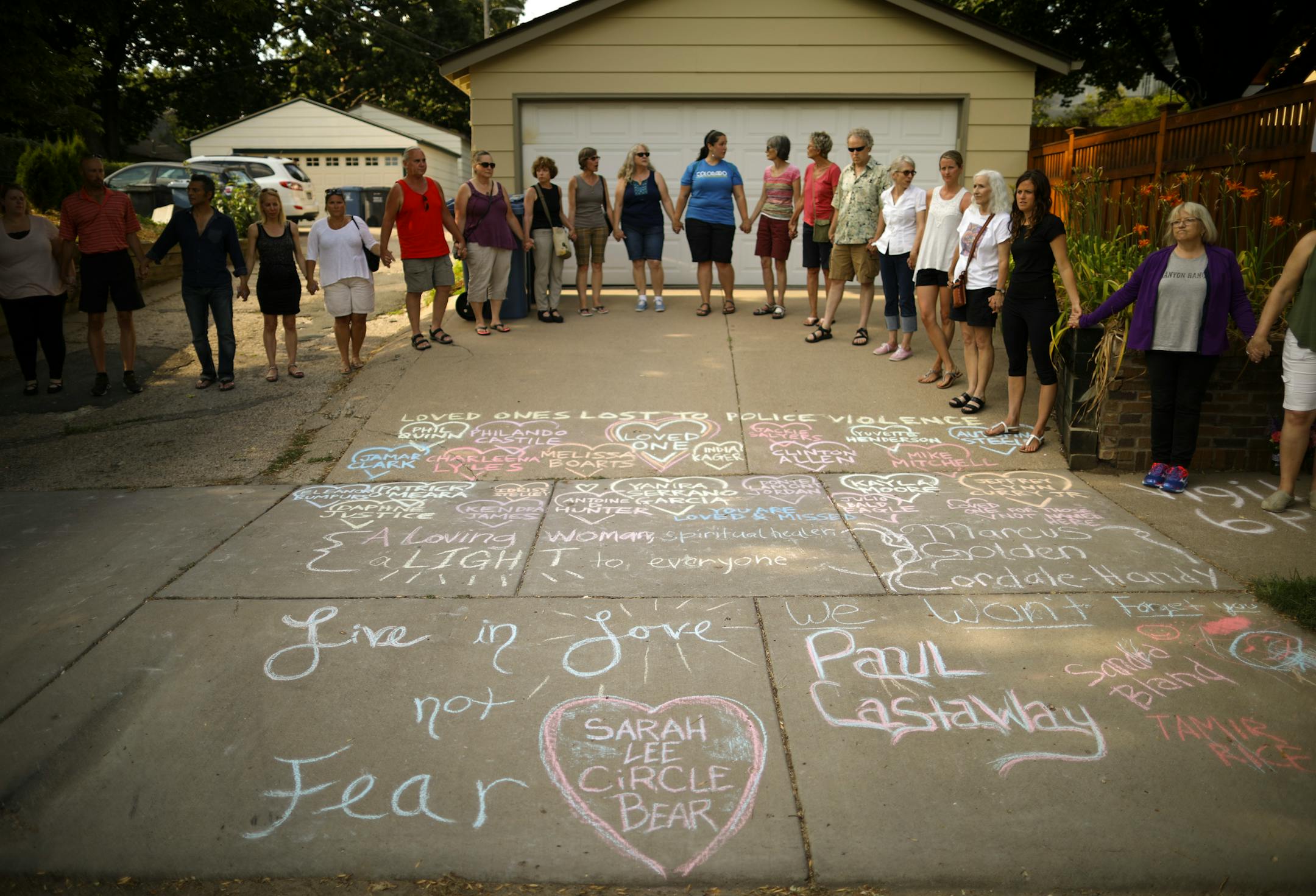 Friends and neighbors of Justine Damond held hands as a vigil to remember began Sunday evening.