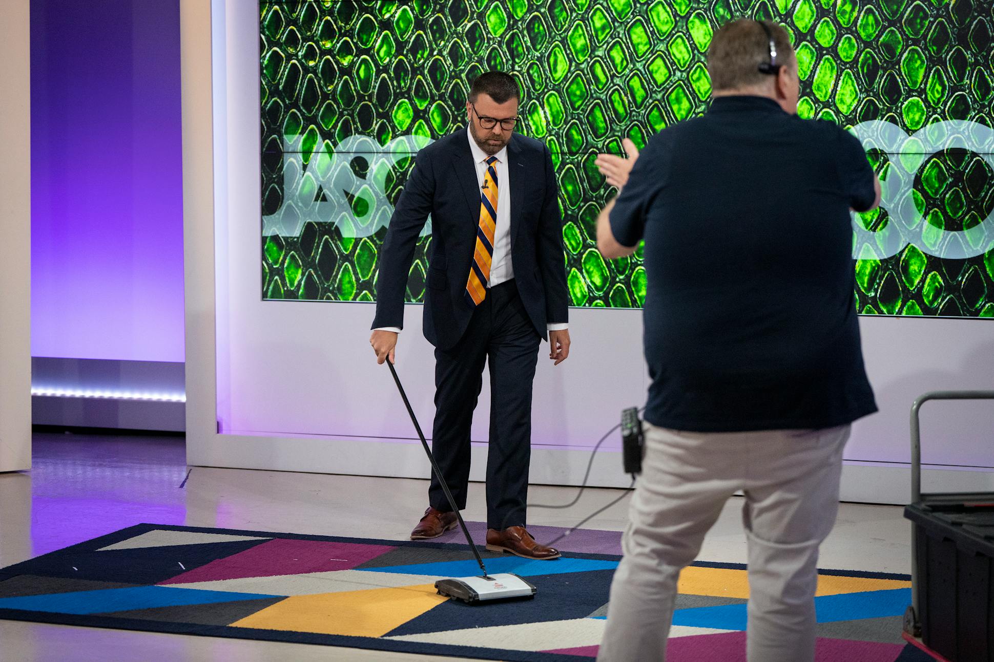 Jason Matheson sweeps the carpet between segments of “The Jason Show.” 