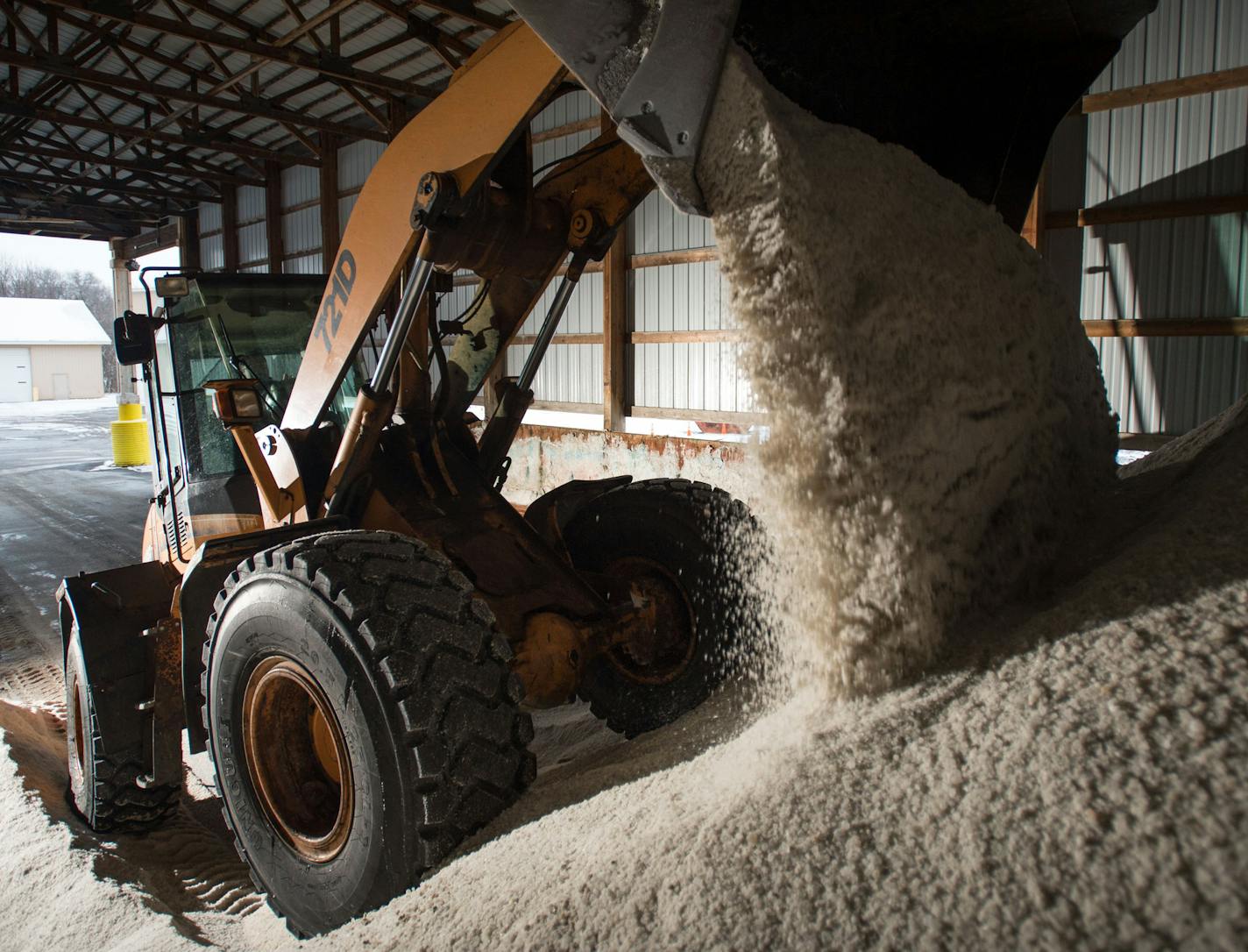 Excess salt from trucks returning from their routes is pushed back on top of the main salt pile with a wheel loader at the Arden Hills Truck Station.