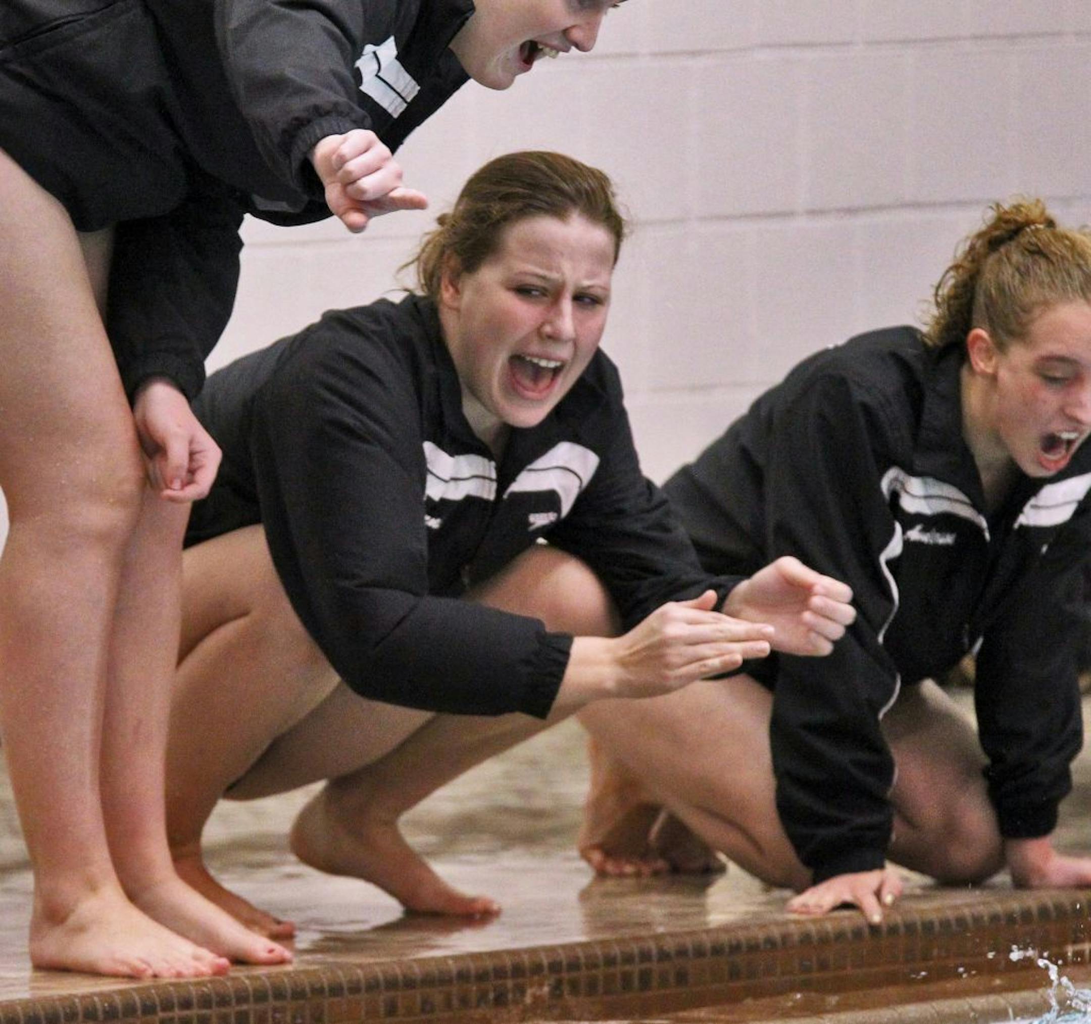Minneapolis Southwest swimmer Madison Kuznia, center was diagnosed with juveline rheumatoid arthritis in 2010 and has been in remission for less than a year. She will compete in an Ironman-distance triathlon in June to raise awareness of her illness. Photo by Marlin Levison • mlevison@startribune.com