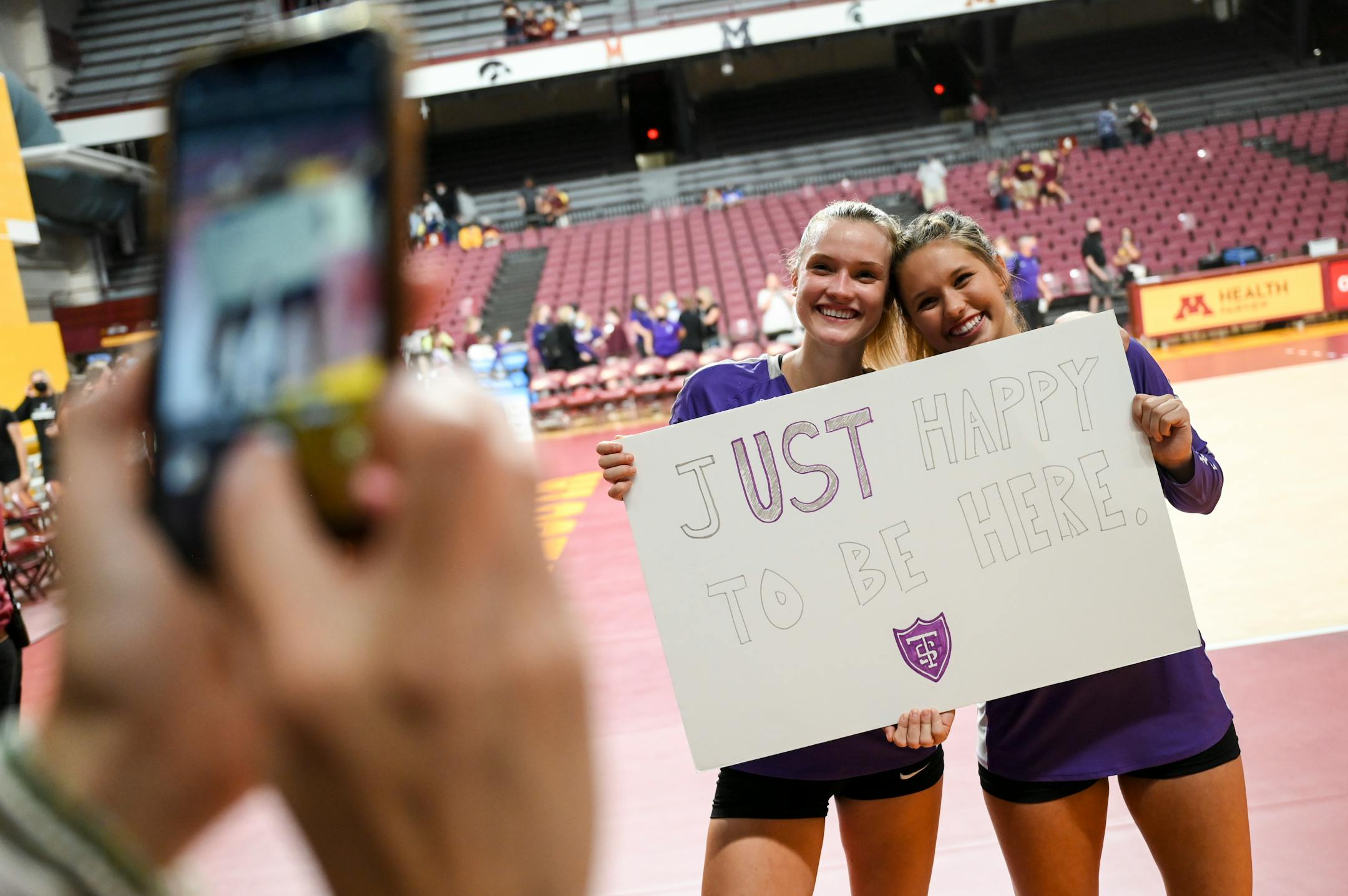 St. Thomas middle blocker Ellie Dammann (1), left, and setter Amelia Wherland (3) took a photo after their match against the University of Minnesota Gophers