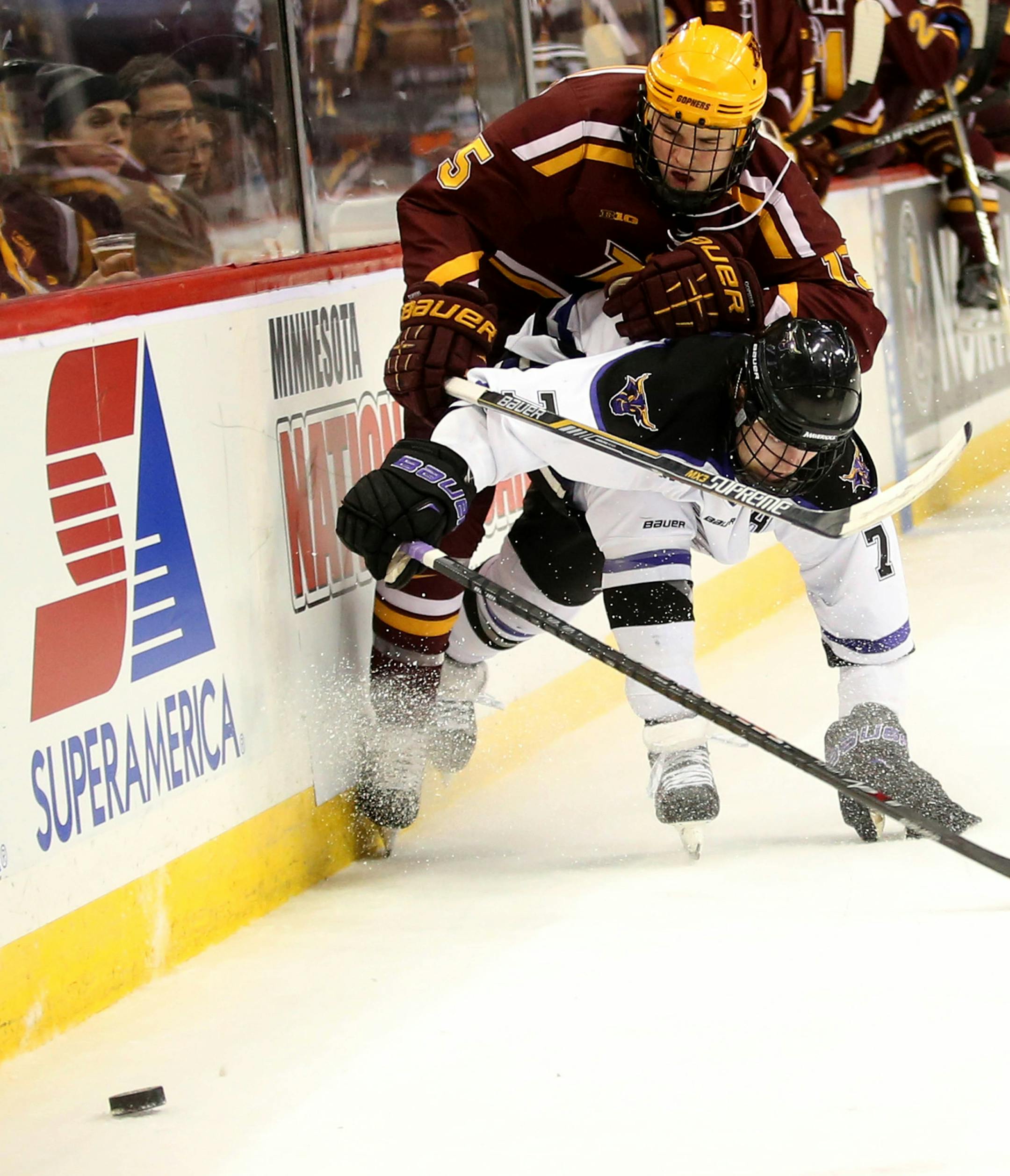 Gopher A.J. Michaelson and Minnesota State's Zach Palmquist fought for the puck along the boards during the second period. ] (KYNDELL HARKNESS/STAR TRIBUNE) kyndell.harkness@startribune.com Gophers vs Minnesota State at the Xcel Energy Center in St. Paul Min., Friday, January 23, 2015. ORG XMIT: MIN1501232203205919