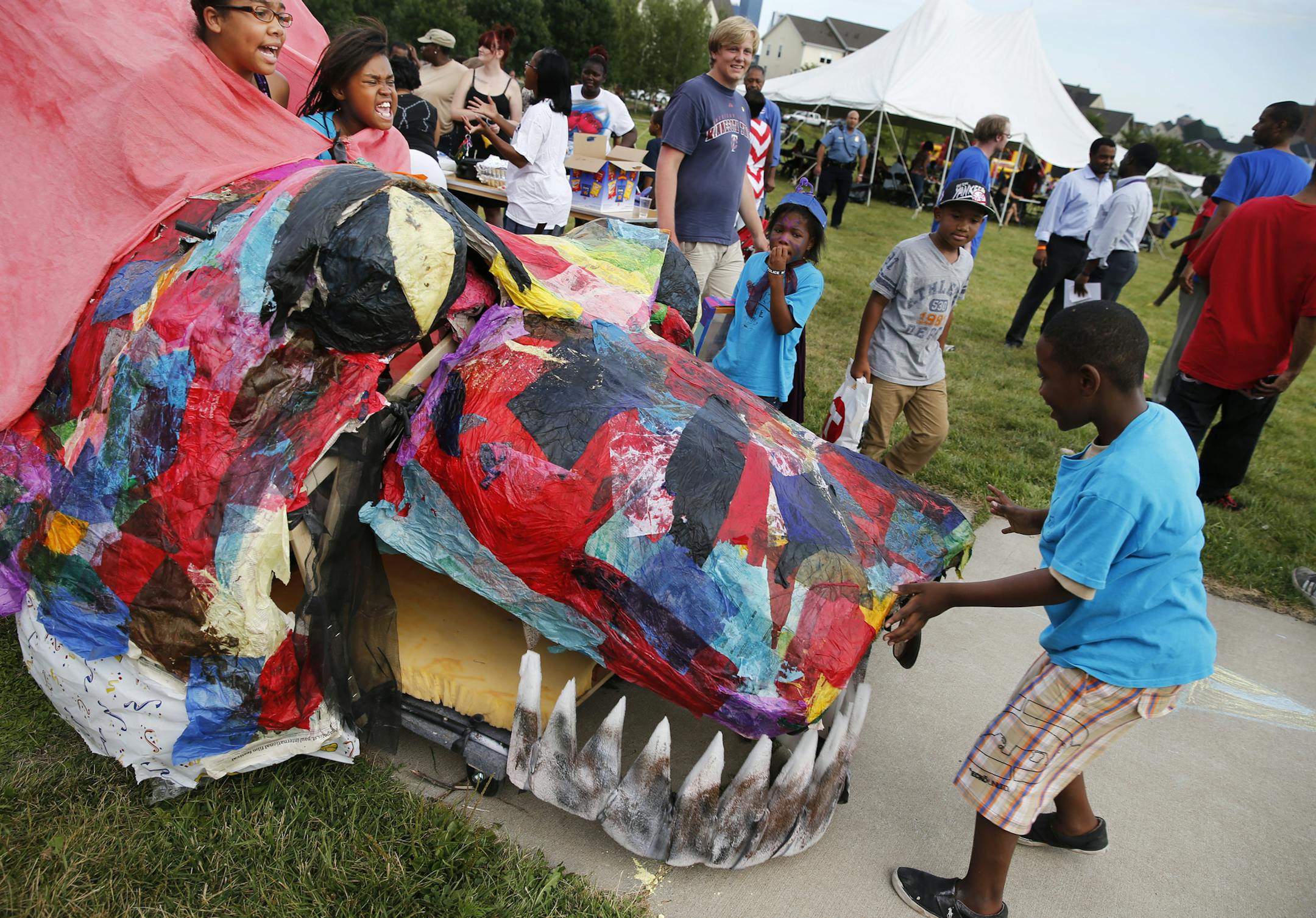 Sadrea Bobbins and Makayla Mabry were quite fiery about navigating their dragon back to its home base after parading around the neighborhood. They were part of a group of kids who spent the summer at the Phyllis Wheatley Center.