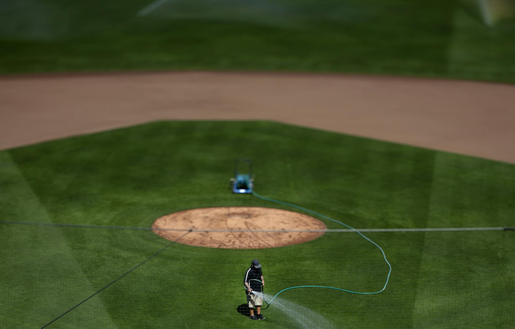 A grounds crew worker watered the field at Hammond Stadium on Tuesday. The Minnesota Twins will hold their first workout for pitchers and catcher tomorrow in Fort Myers.