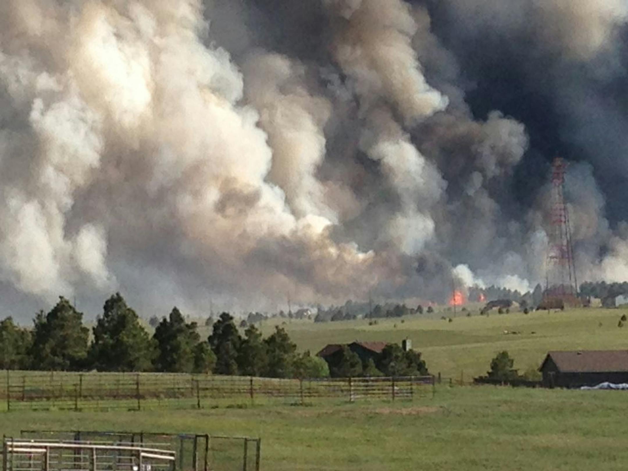 In this cell phone photo provided by Jean-Michel Bertrand, smoke from the Black Forest fire rises north of Colorado Springs, Colo.