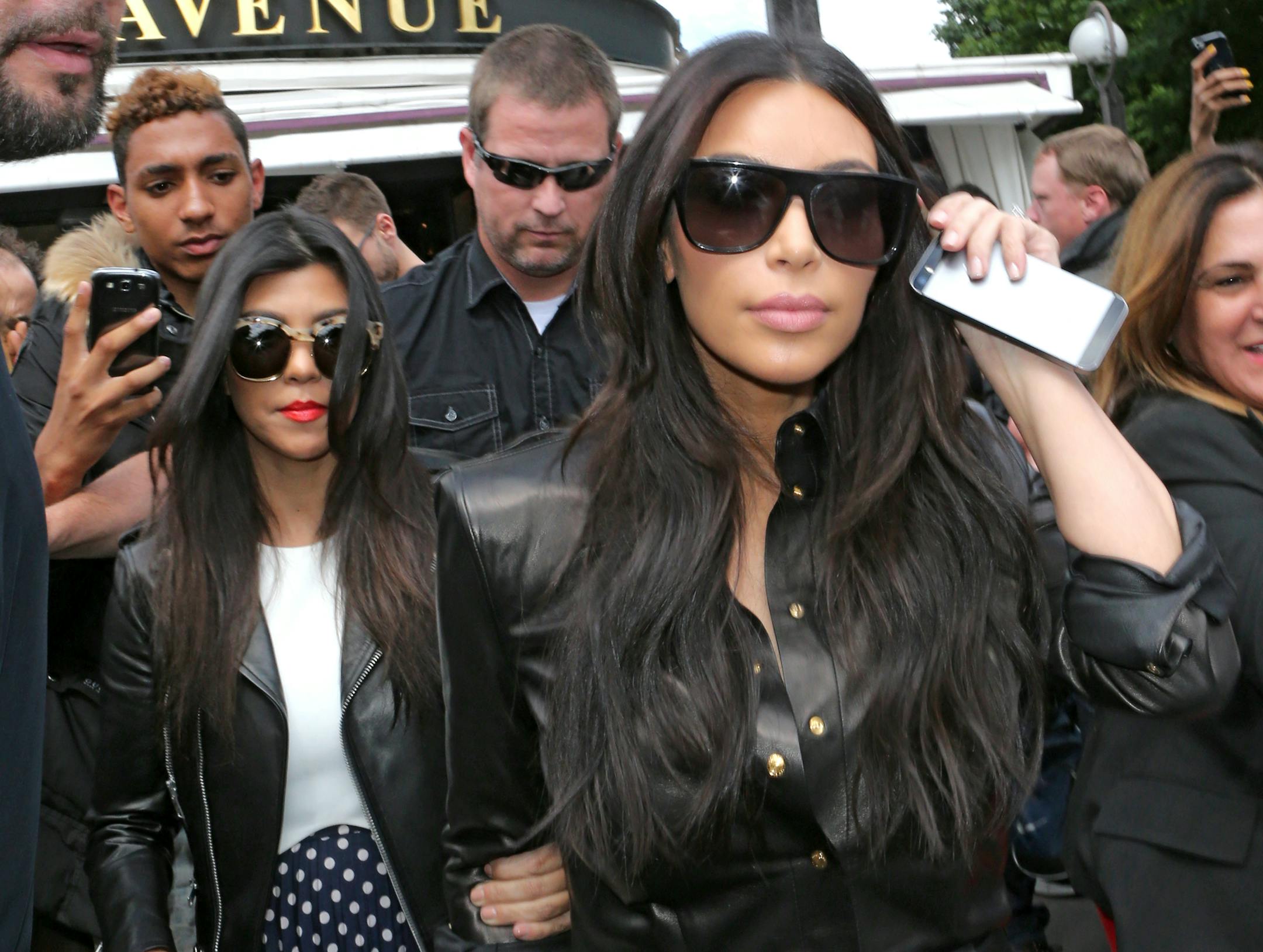 Kim Kardashian, front and Kourtney Kardashian, left, leave at a restaurant in Paris, Thursday, May 22, 2014. The gates of the Chateau de Versailles, once the digs of Louis XIV, will be thrown open to Kim Kardashian, Kanye West and their guests for a private evening this week ahead of their marriage (AP Photo/Jacques Brinon)