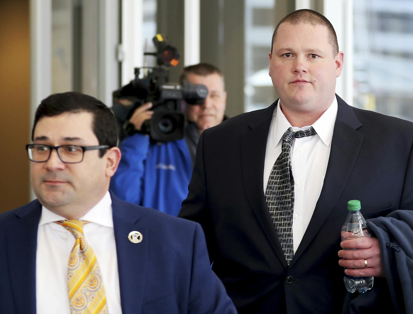 Former Minneapolis police officer Christopher Reiter, 36, right, arrives at court with his attorney Robert Fowler Thursday, March 16, 2017, at the Hennepin County Jail in Minneapolis, Minn. Reiter is accused of kicking a suspect who was on his hands and knees during an incident in spring of 2016. (David Joles /Star Tribune via AP)