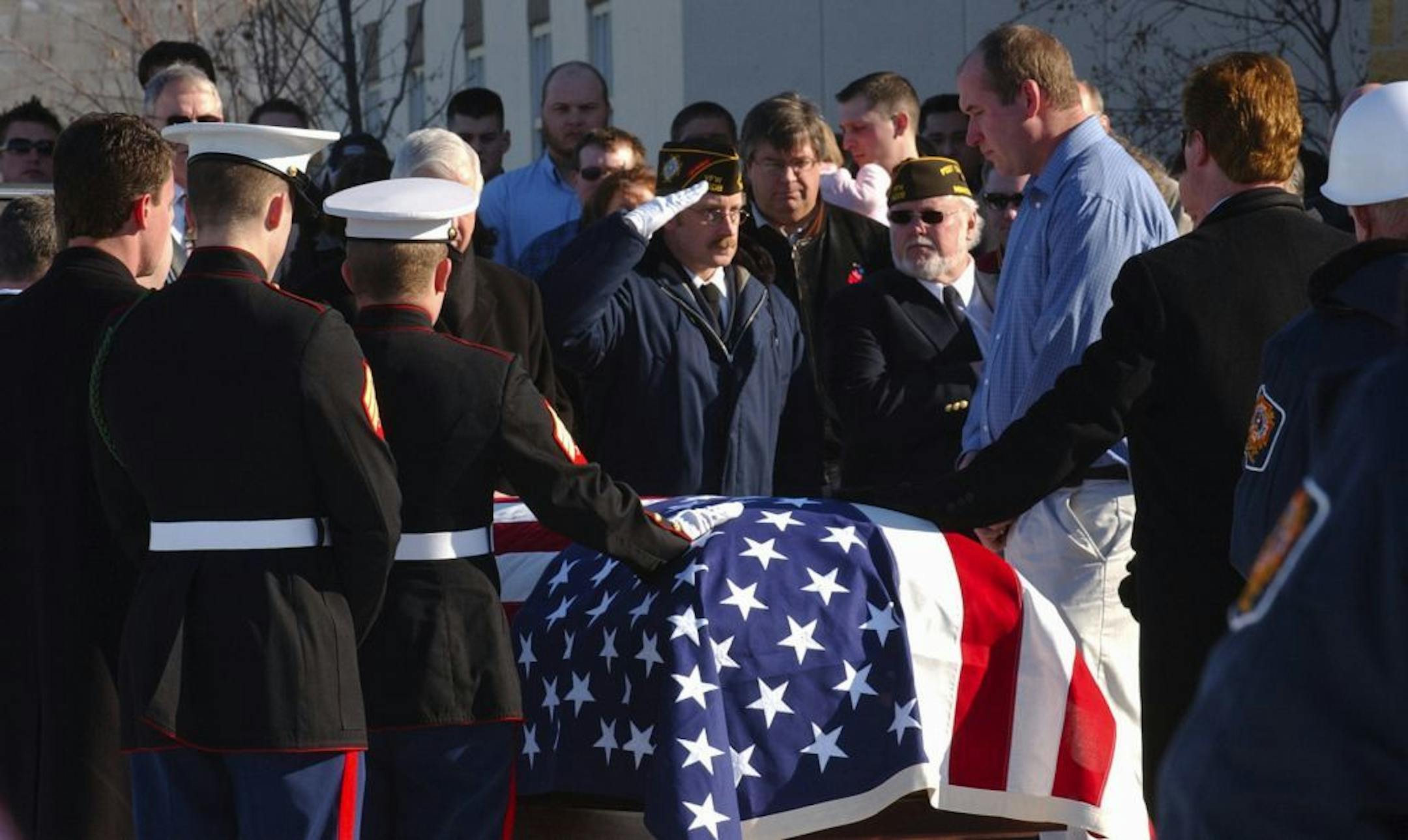 A member of the Prior Lake VFW salutes the flag-draped coffin of Marine Jonathan Schulze on Saturday, Jan. 27, 2007, in Stewart, Minn. Schulze tried to live with the nightmares and grief he brought home after serving as a U.S. Marine in Iraq, but it overwhelmed him. And he didn't get the help he needed to survive, his family claims. Schulze committed suicide four days after telling Veterans Administration workers he was thinking about killing himself, his father and stepmother said.