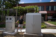 Mim’s Cafe owner Mahmoud Shahin stood next to the electrical boxes in front of his St. Paul cafe in August. 