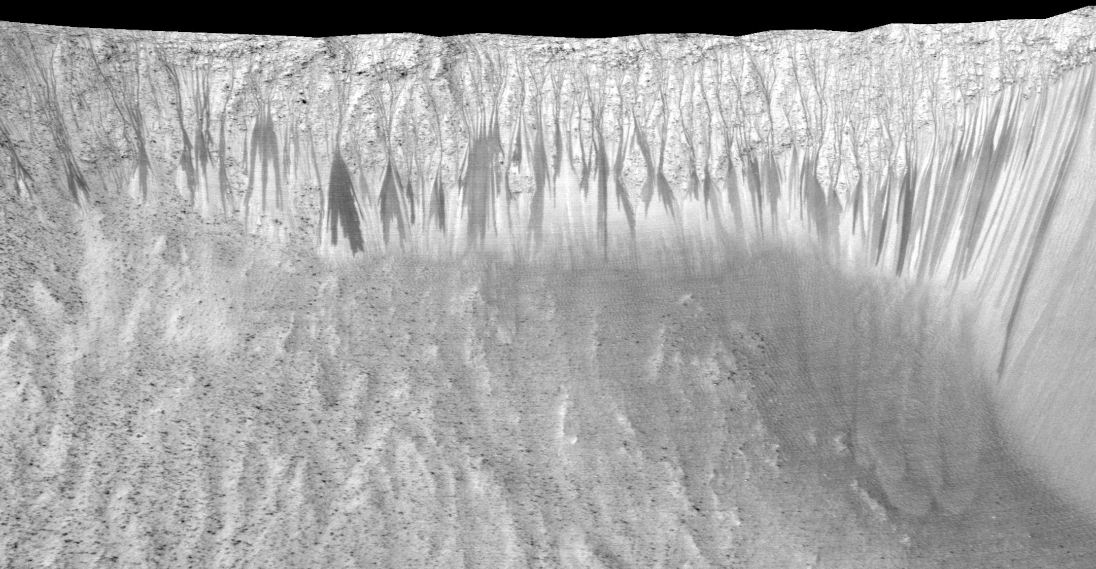 In an undated handout photo, dark narrow streaks, up to a few hundred yards long, are seen along many slopes on Mars including Garni Crater. Scientists reported on Monday definitive signs of liquid water on the surface of present-day Mars, a finding that will fuel speculation that life, if it ever arose there, could persist to now. (Jet Propulsion Laboratory/University of Arizona/NASA) -- NO SALES; FOR EDITORIAL USE ONLY WITH STORY SLUGGED MARS WATER BY KENNETH CHANG. ALL OTHER USE PROHIBITED. -