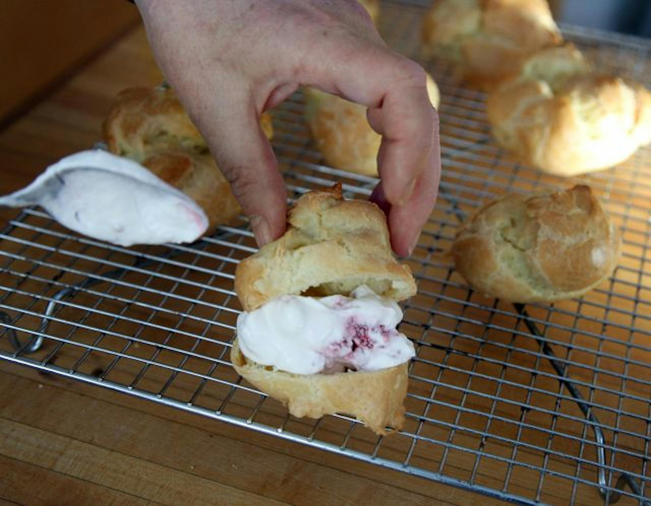 Filling sliced cream puffs.