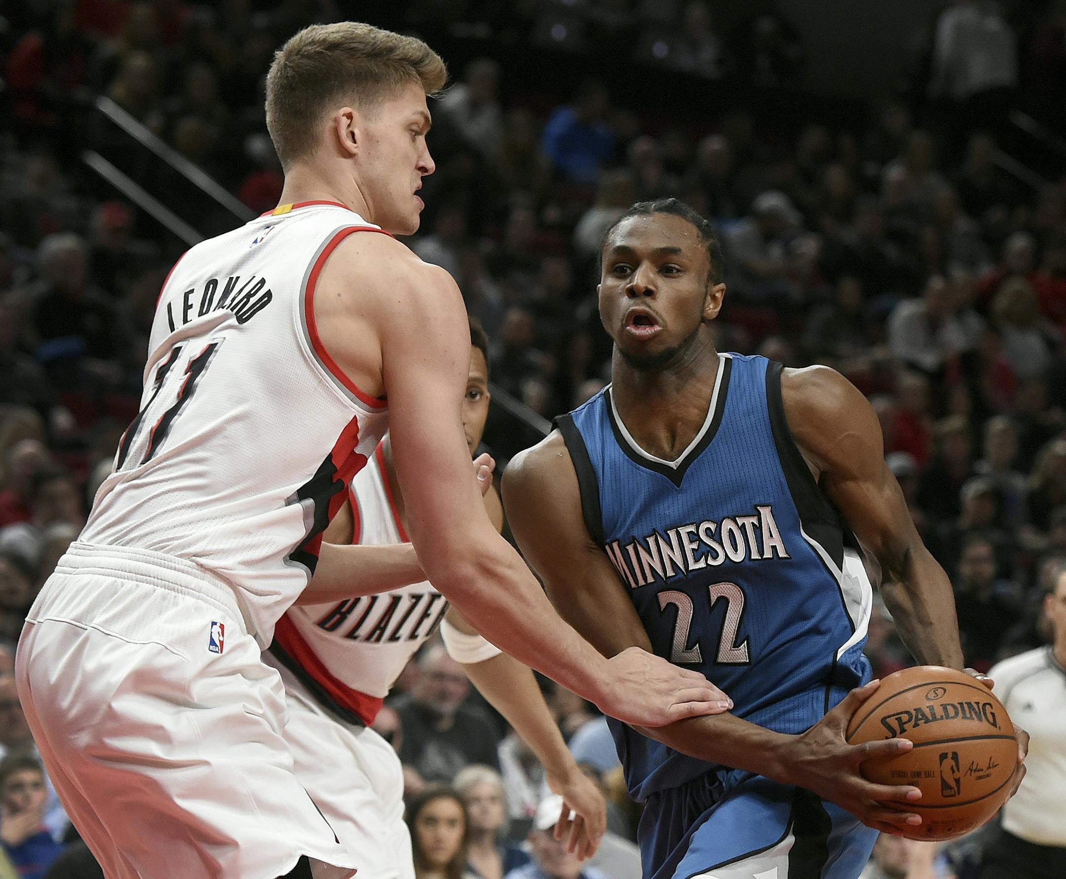 Portland Trail Blazers forward Meyers Leonard grabs the forearm of Minnesota Timberwolves forward Andrew Wiggins during the first half of an NBA basketball game in Portland, Ore., Saturday, March 25, 2017. (AP Photo/Steve Dykes)
