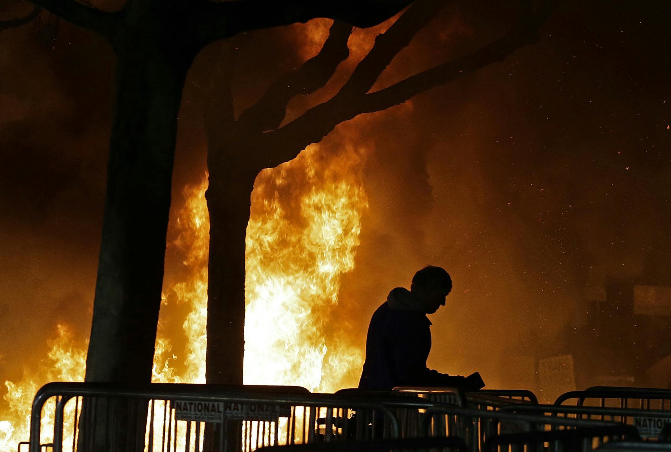 FILE - In this Feb. 1, 2017 file photo, a fire set by demonstrators protesting a scheduled speaking appearance by Breitbart News editor Milo Yiannopoulos burns on Sproul Plaza on the University of California, Berkeley campus. Northern California police and civic leaders are hoping for calm, but bracing for violence this weekend when hundreds, possibly thousands, of demonstrators of all stripes flock to the San Francisco Bay Area for dueling political rallies. Law enforcement officials in San Fra
