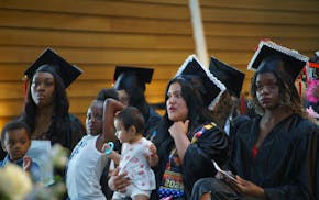 Graduates sit together at Hennepin County's Recognition of Success high school graduation ceremony on Friday, May 30 in Minneapolis.