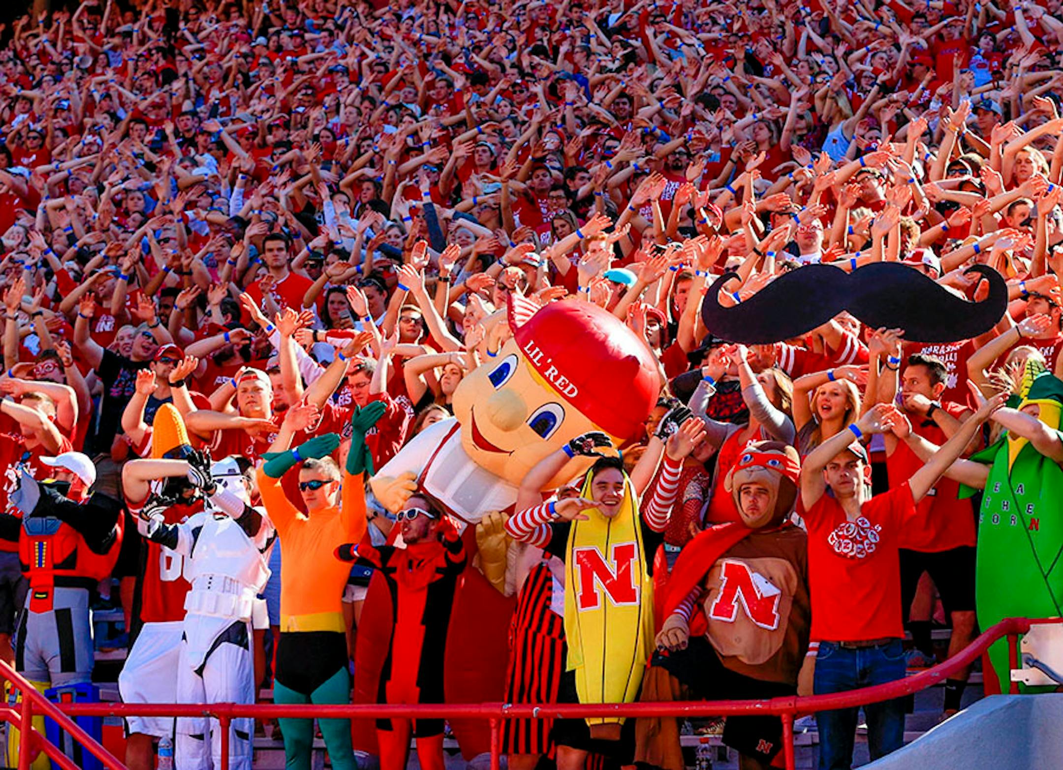 Nebraska mascot Lil' Red joins fans as they celebrate a Nebraska touchdown against Southern Miss earlier this season.