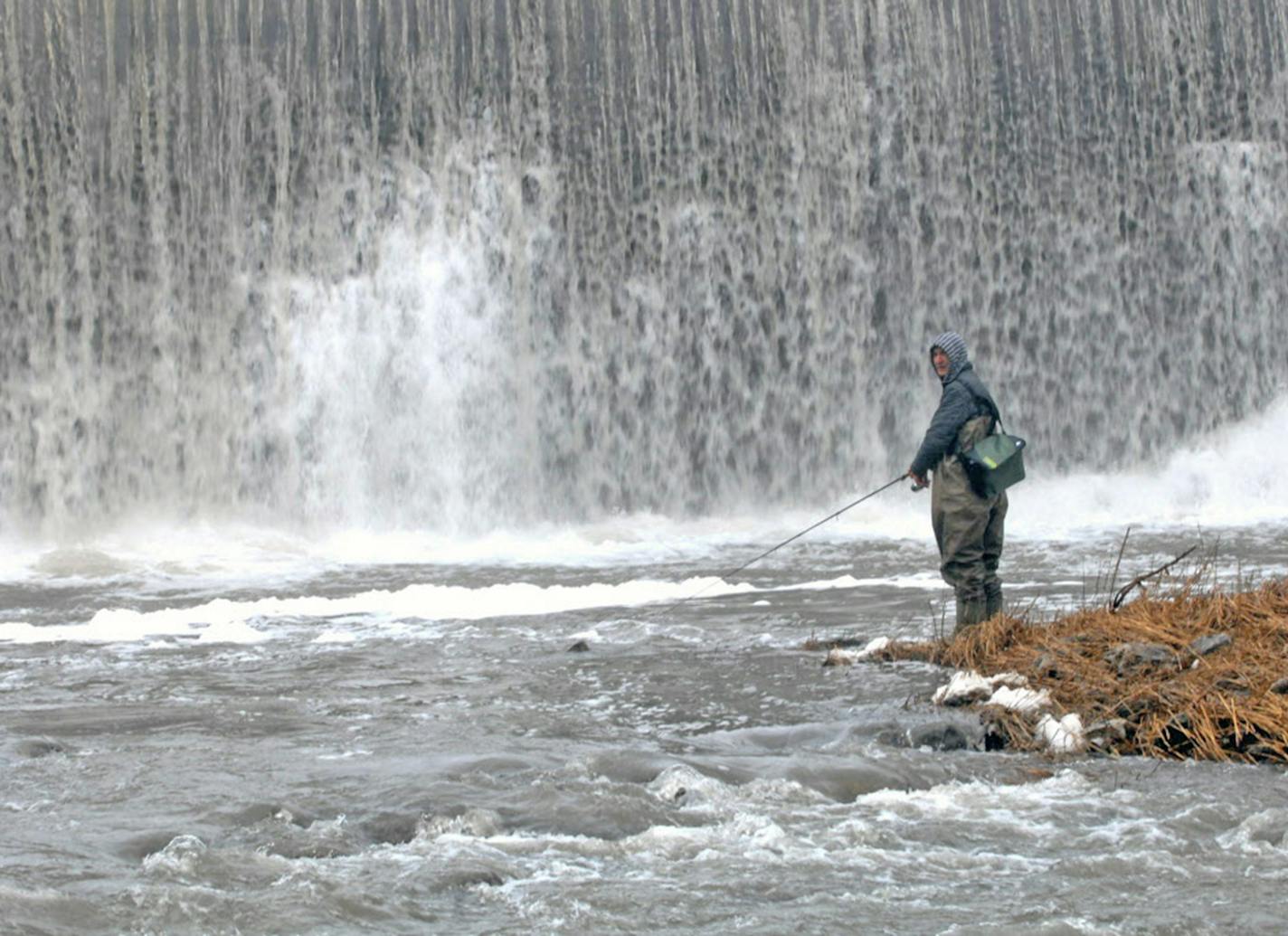 Trout fishing throughout southeast Minnesota is dependent to a degree on fish raised at the DNR's Lanesboro hatchery. Fishing is also poipular in and near Lanesboro. Here an angler cast for trout beneath the dam near the center of that town. ORG XMIT: MIN1304131058122106