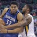 Utah Jazz forward Derrick Favors, right, defends against Minnesota Timberwolves center Karl-Anthony Towns (32) during the first half in an NBA basketb