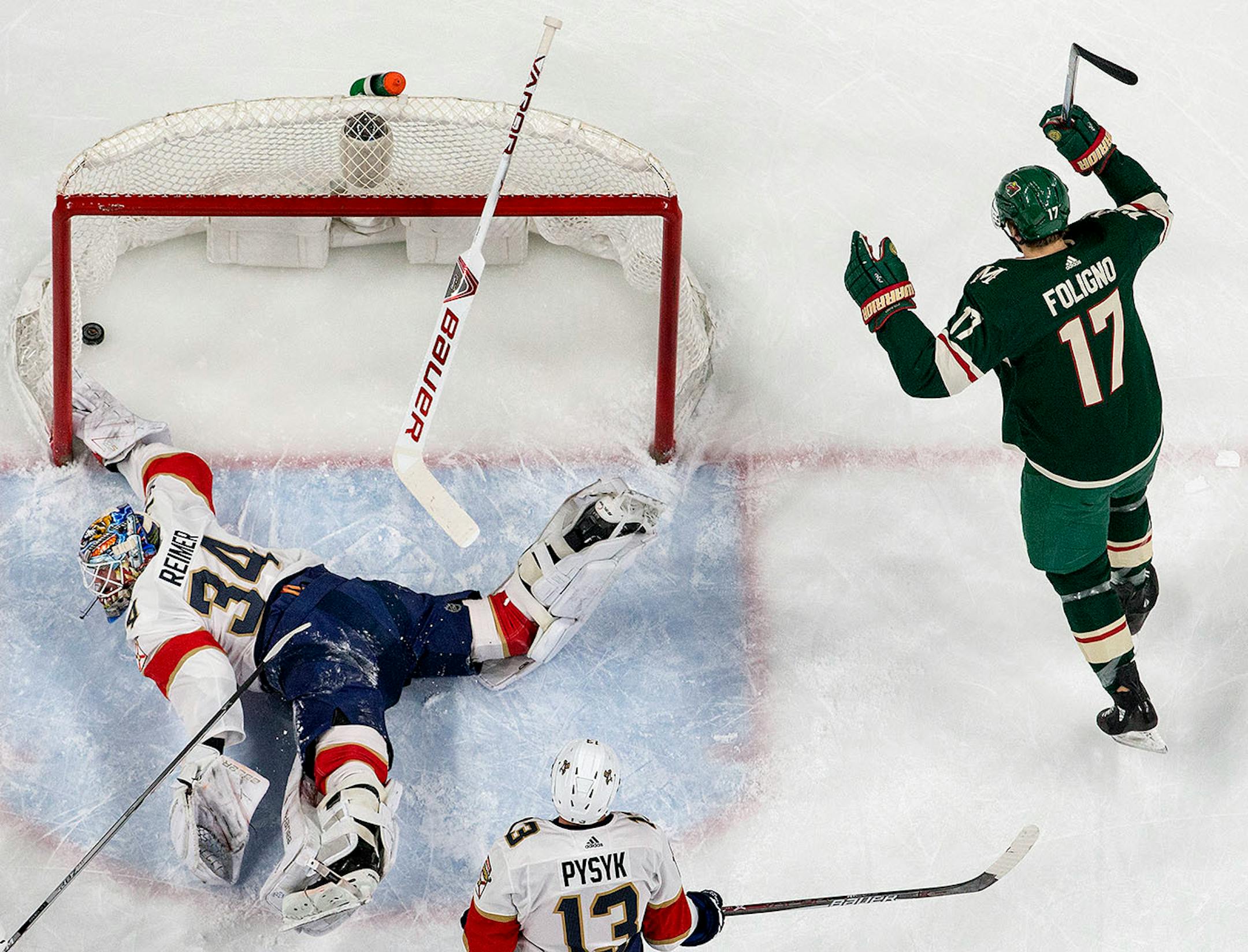 Matt Cullen (not seen in photo) got the puck past Panthers goalie James Reimer (34) for a goal in the first period.