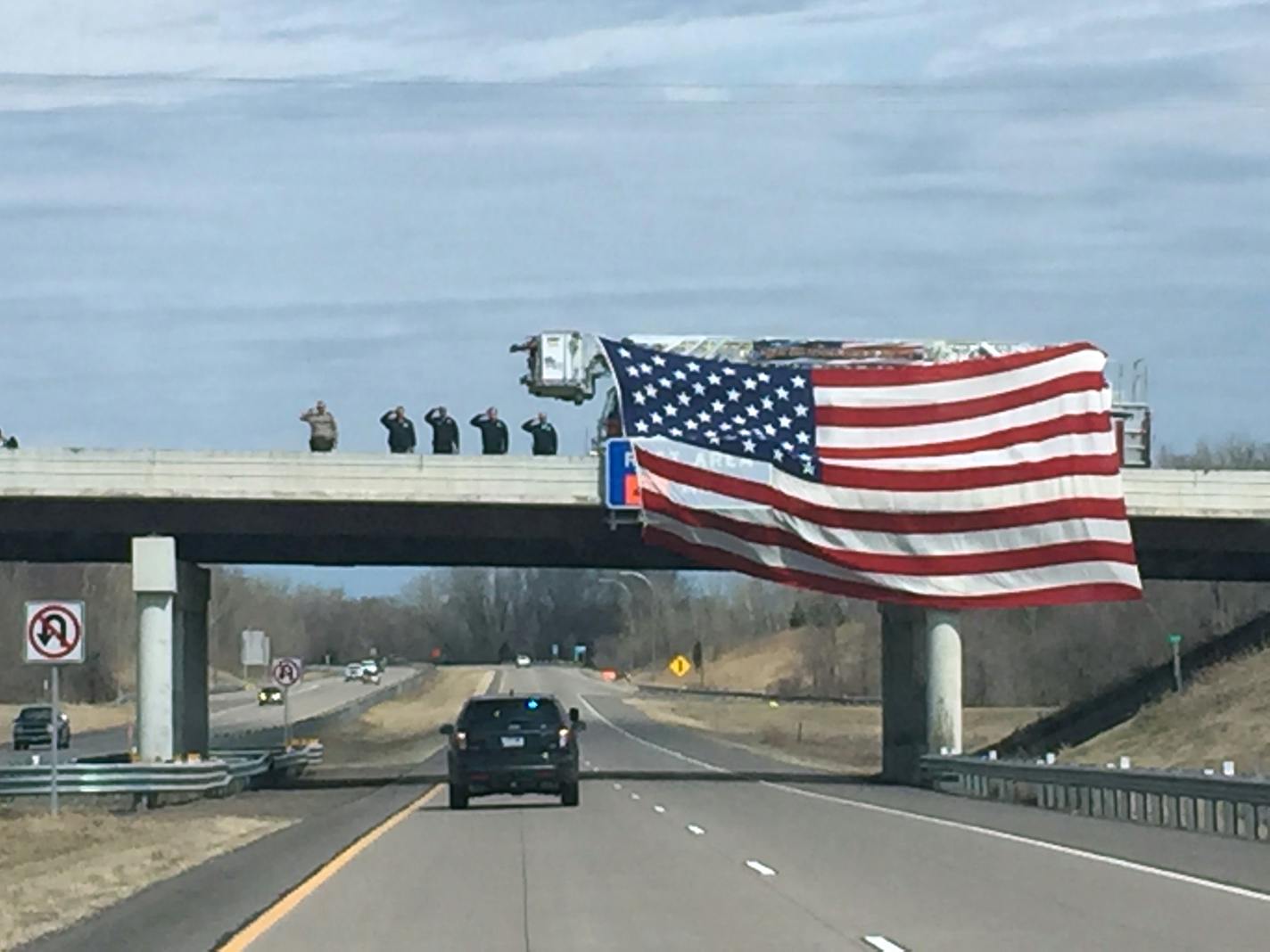 Authorities salute a procession for Minnesota Department of Natural Resources officer Eugene Wynn Jr., 43, on Sunday.