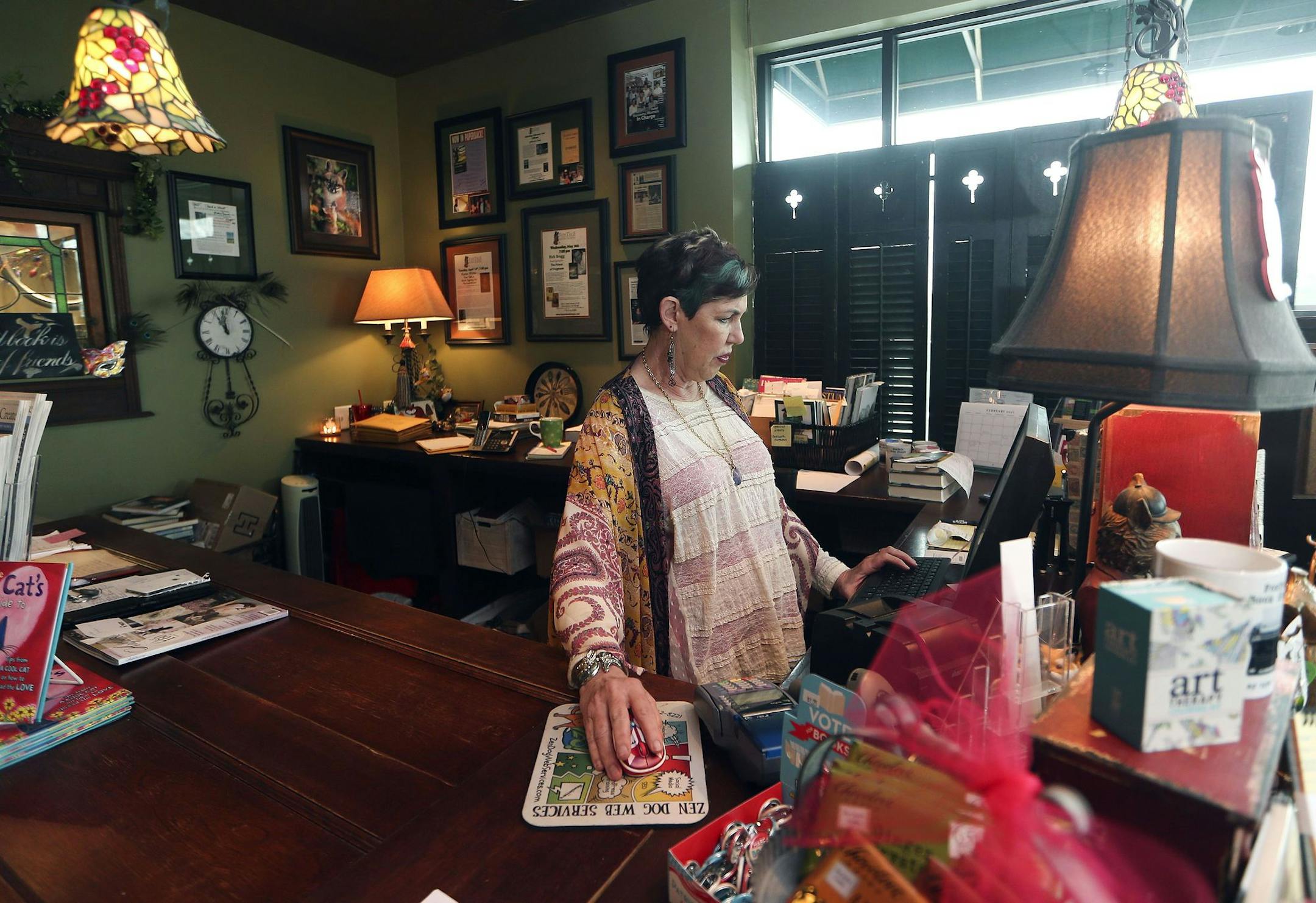 In this Wednesday, Feb. 3, 2016, photo, Ellen Ward, owner of FoxTale Book Shoppe, works behind the counter in Woodstock, Ga. Sales at FoxTale Book Shoppe have increased between 15 percent and 25 percent a year since it opened in 2007 despite nearby big box competitors, including a Barnes & Noble that opened in 1995, says Ward. (AP Photo/John Bazemore) ORG XMIT: GAJB204